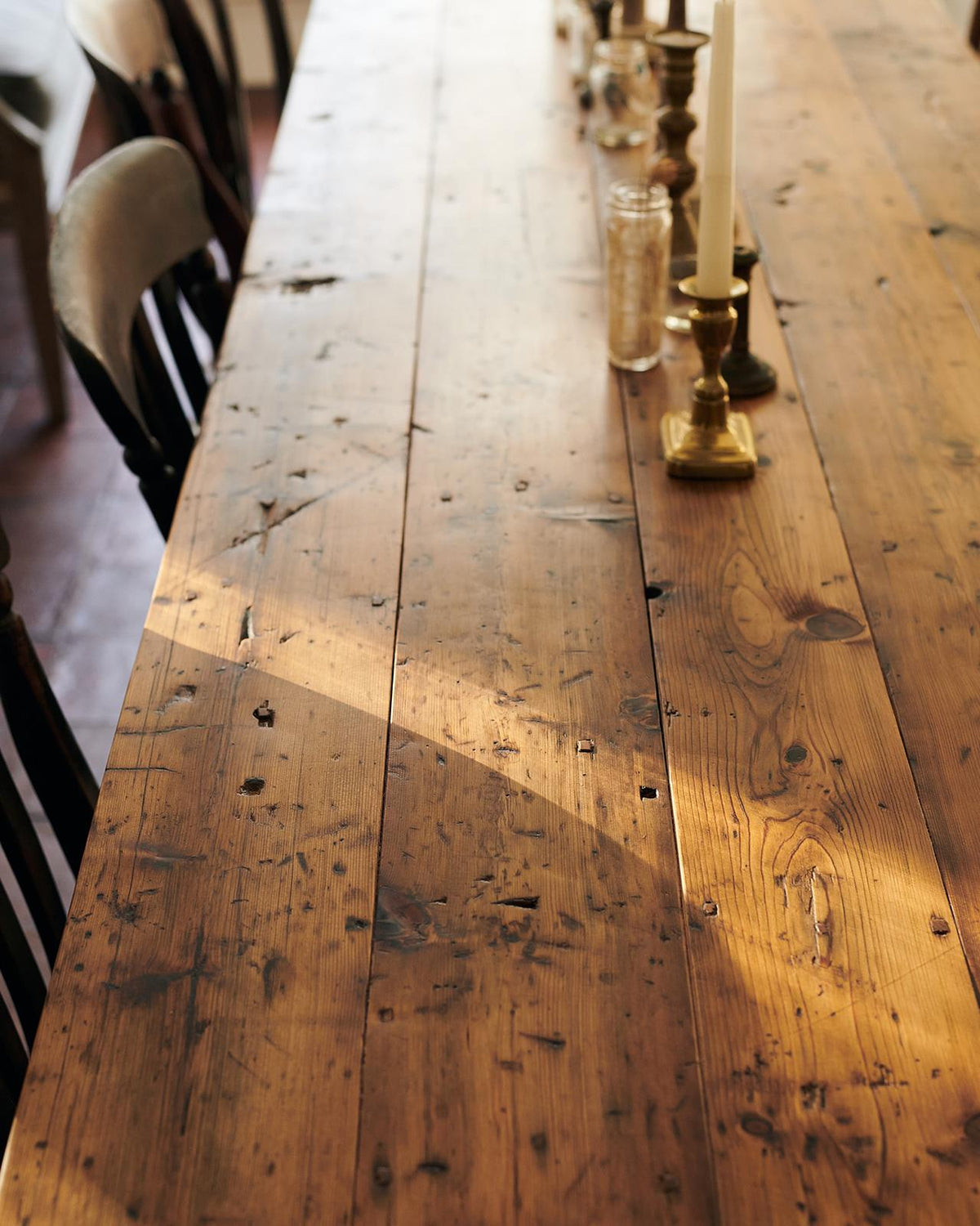 A close-up view of a rustic pine tabletop from a banquet-style dining table. TEST