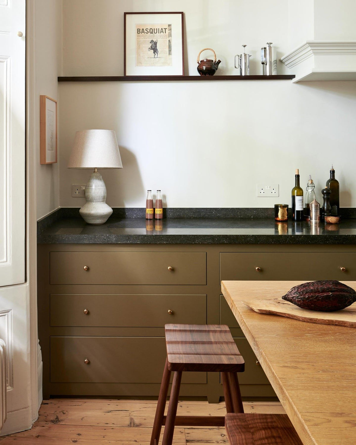 A straight-on view of a mossy green painted Georgian-style kitchen with rows of pan drawers fitted with classic knobs in a bright polished bronze finish.|Polished Bronze Medium shown TEST
