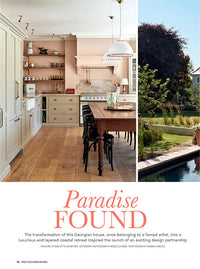 A page of a magazine, the bottom section has pink text that reads 'Paradise Found'. Above are two photos, the one of the left is of a shaker-style kitchen and the other is a smaller section showing a large garden.