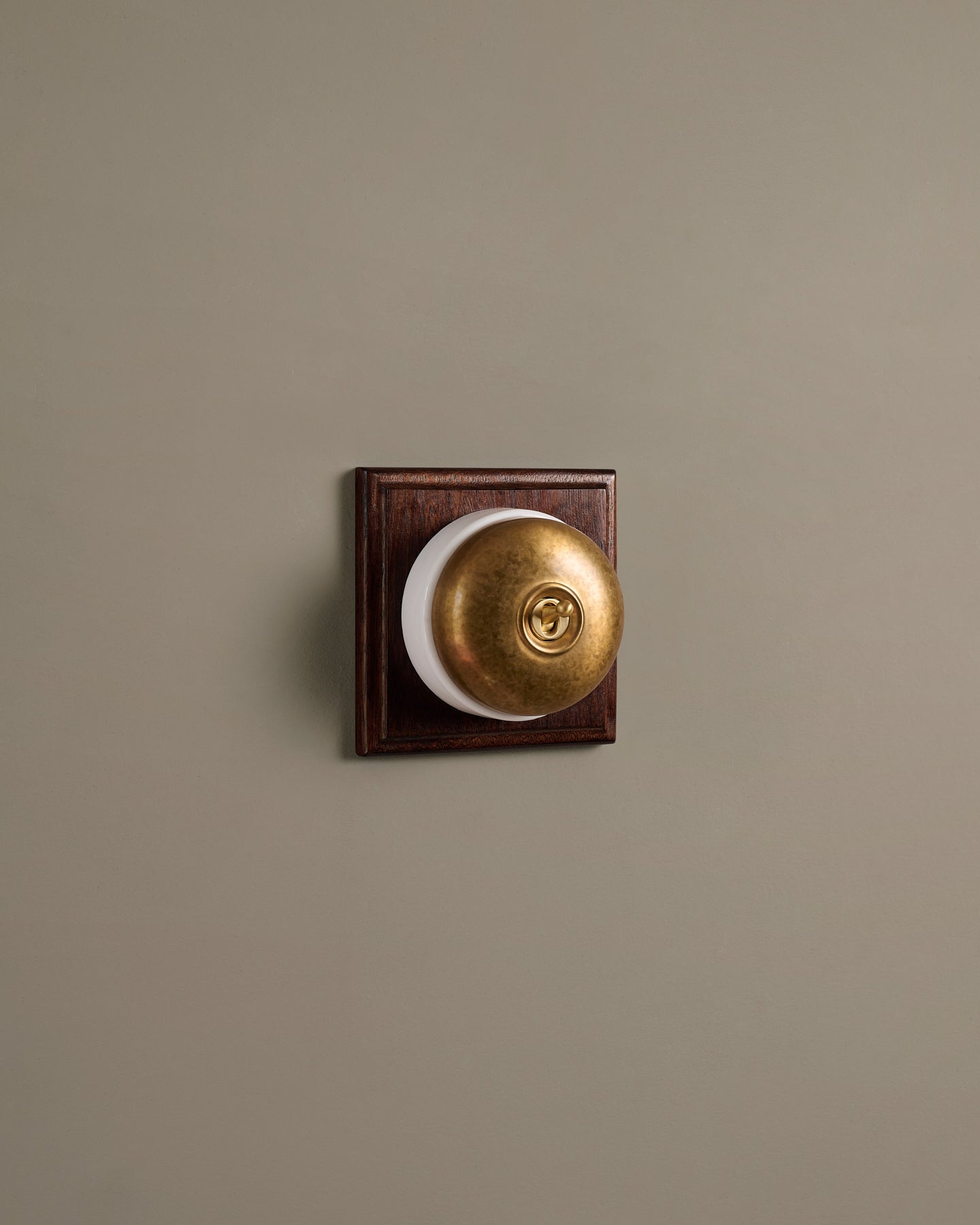 The Dolly Toggle Switch (1 Gang & Mahogany Finish Pattress) - Aged Brass with White Base.