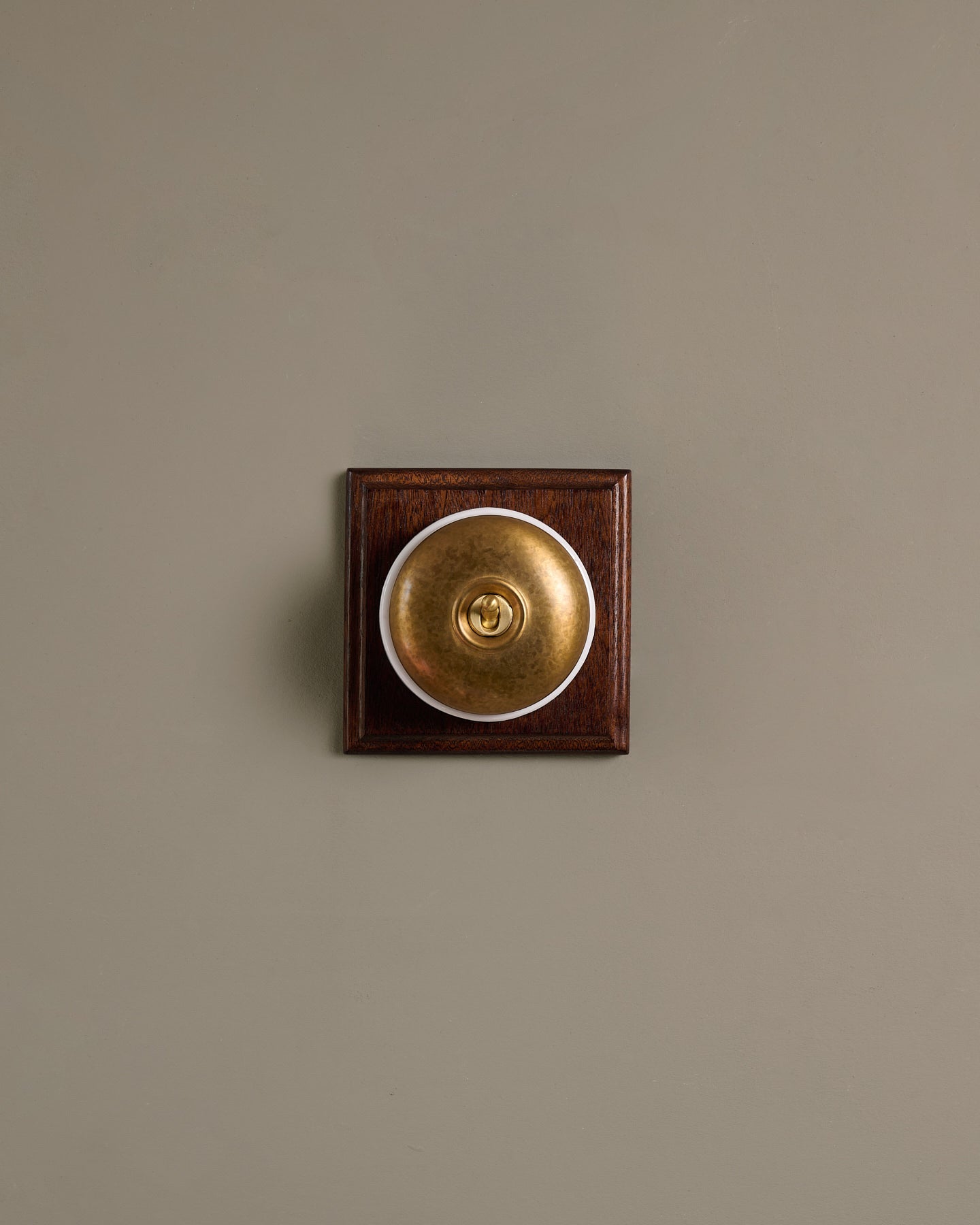 The Dolly Toggle Switch (1 Gang & Mahogany Finish Pattress) - Aged Brass with White Base.