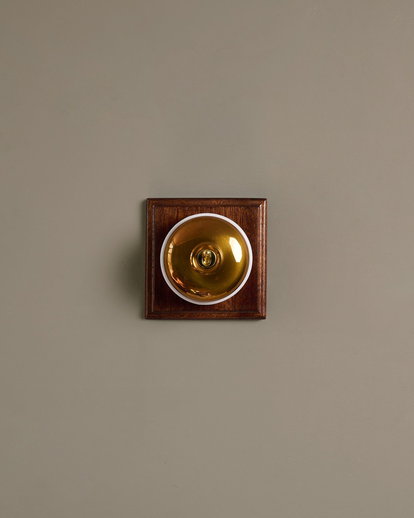 The Dolly Toggle Switch (1 Gang & Mahogany Finish Pattress) - Heirloom Brass with White Base.
