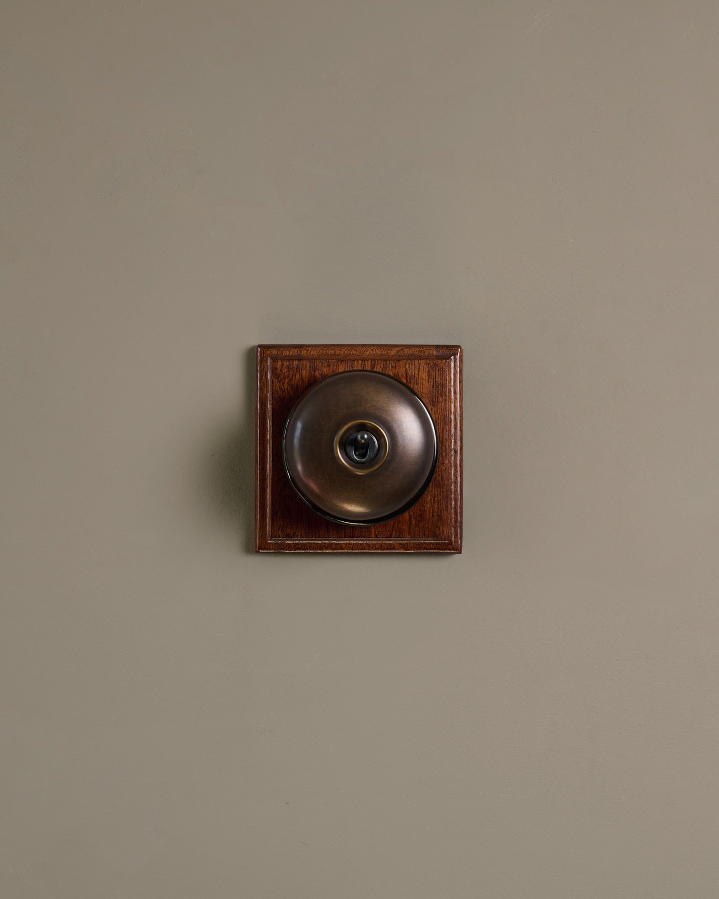 The Dolly Toggle Switch (1 Gang & Mahogany Finish Pattress) - Oxidised Brass with Black Base.