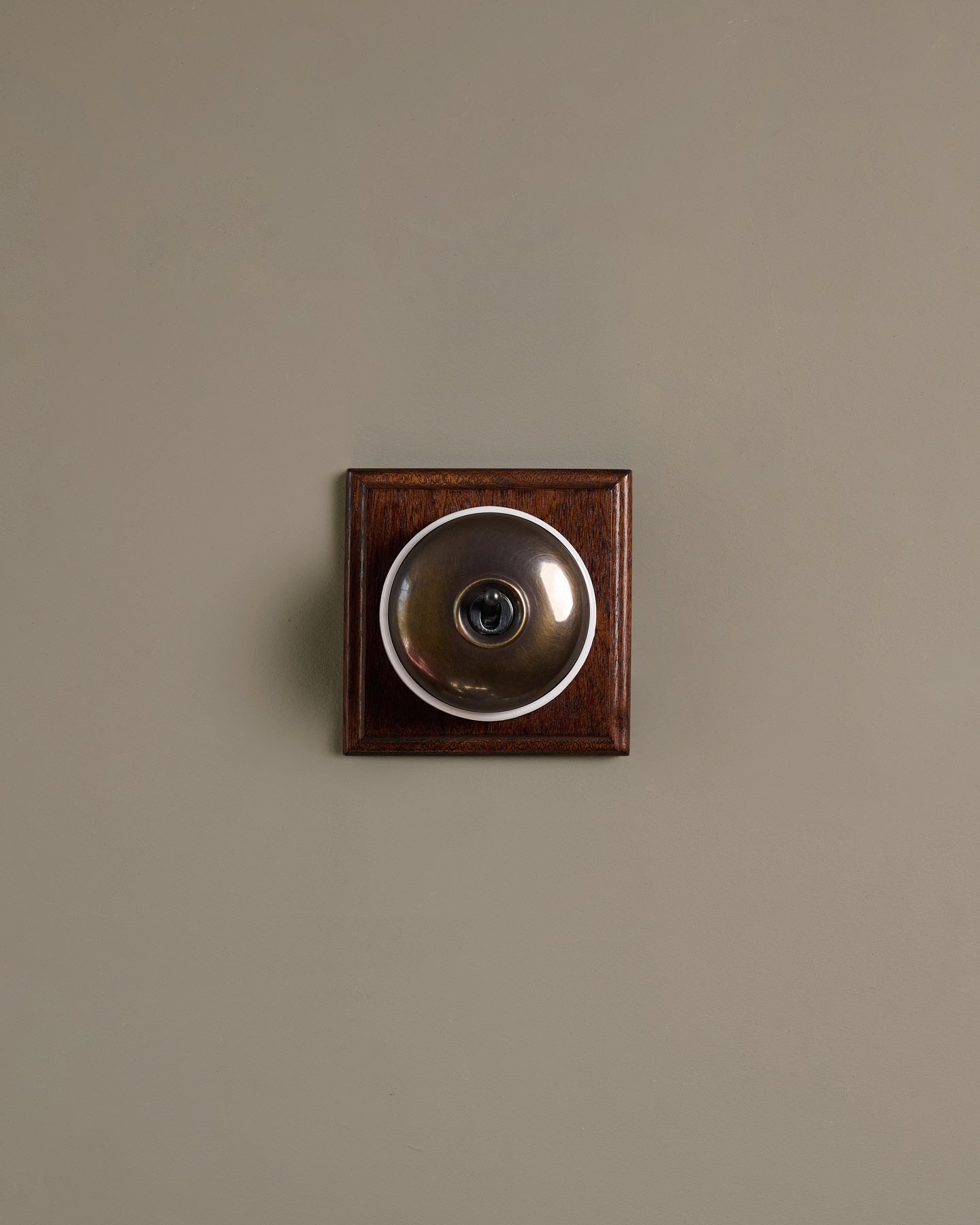The Dolly Toggle Switch (1 Gang & Mahogany Finish Pattress) - Oxidised Brass with White Base.