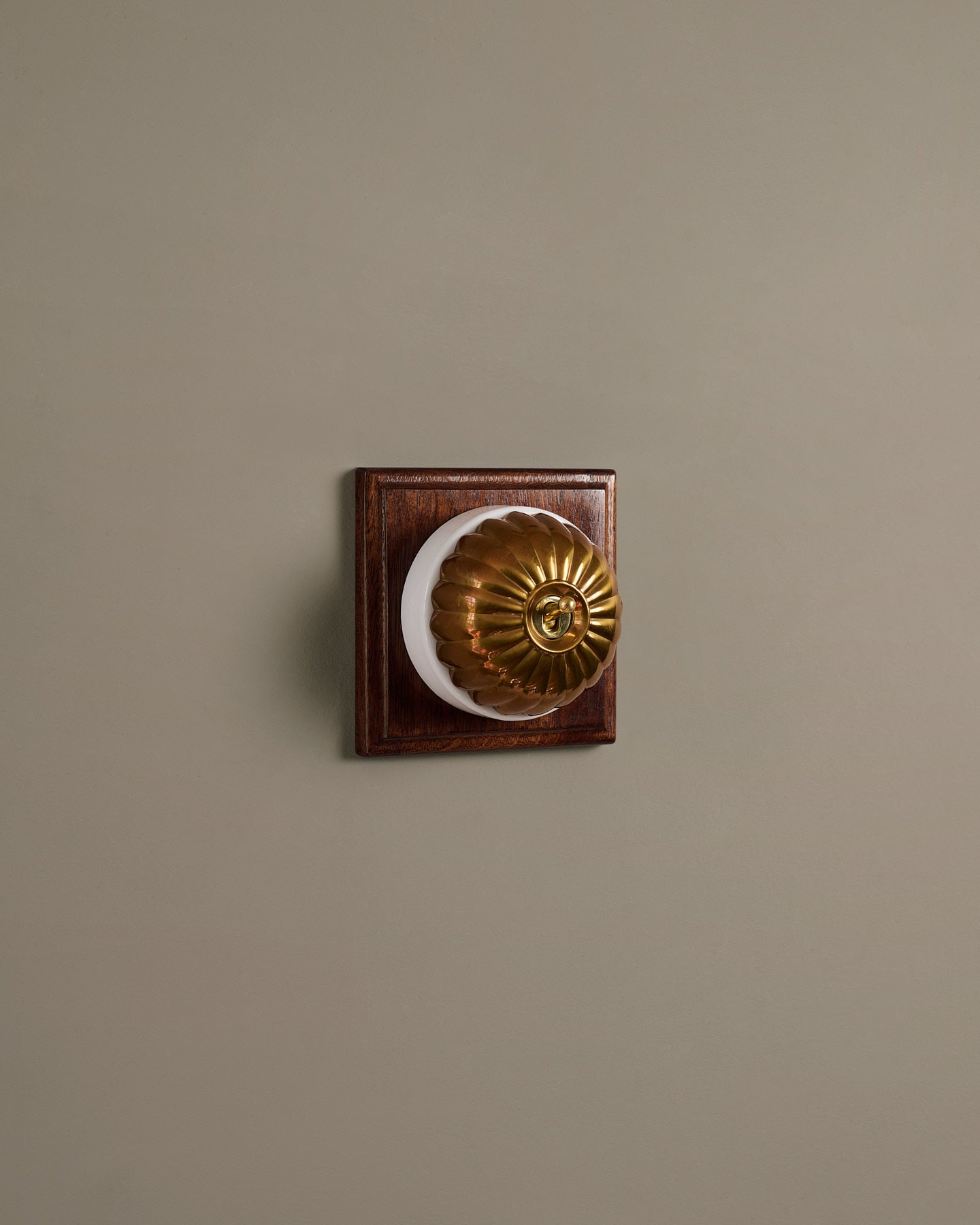 The Jelly Toggle Switch (1 Gang & Mahogany Finish Pattress) - Heirloom Brass with White Base.