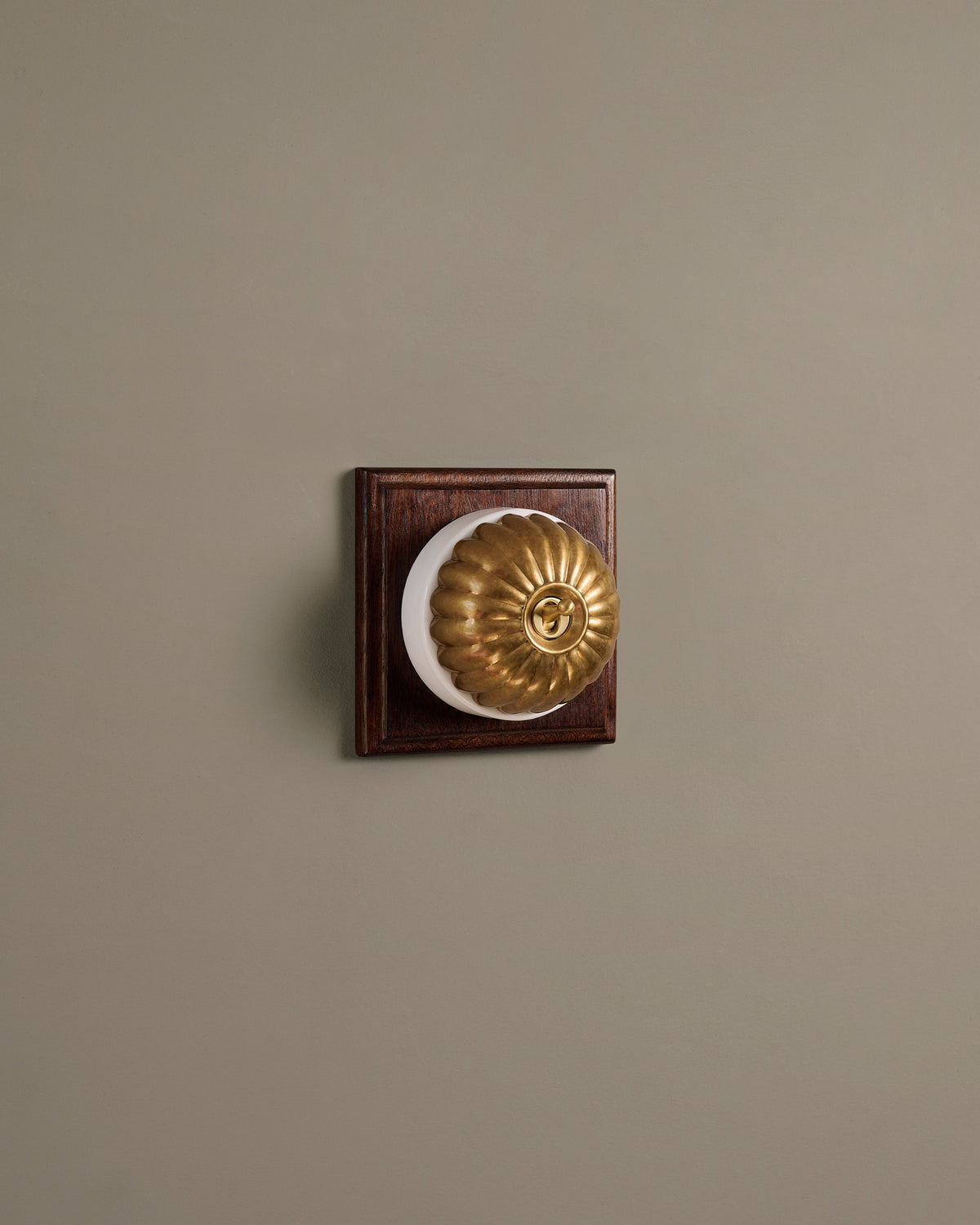 The Jelly Toggle Switch (1 Gang & Mahogany Finish Pattress) - Aged Brass with White Base. TEST
