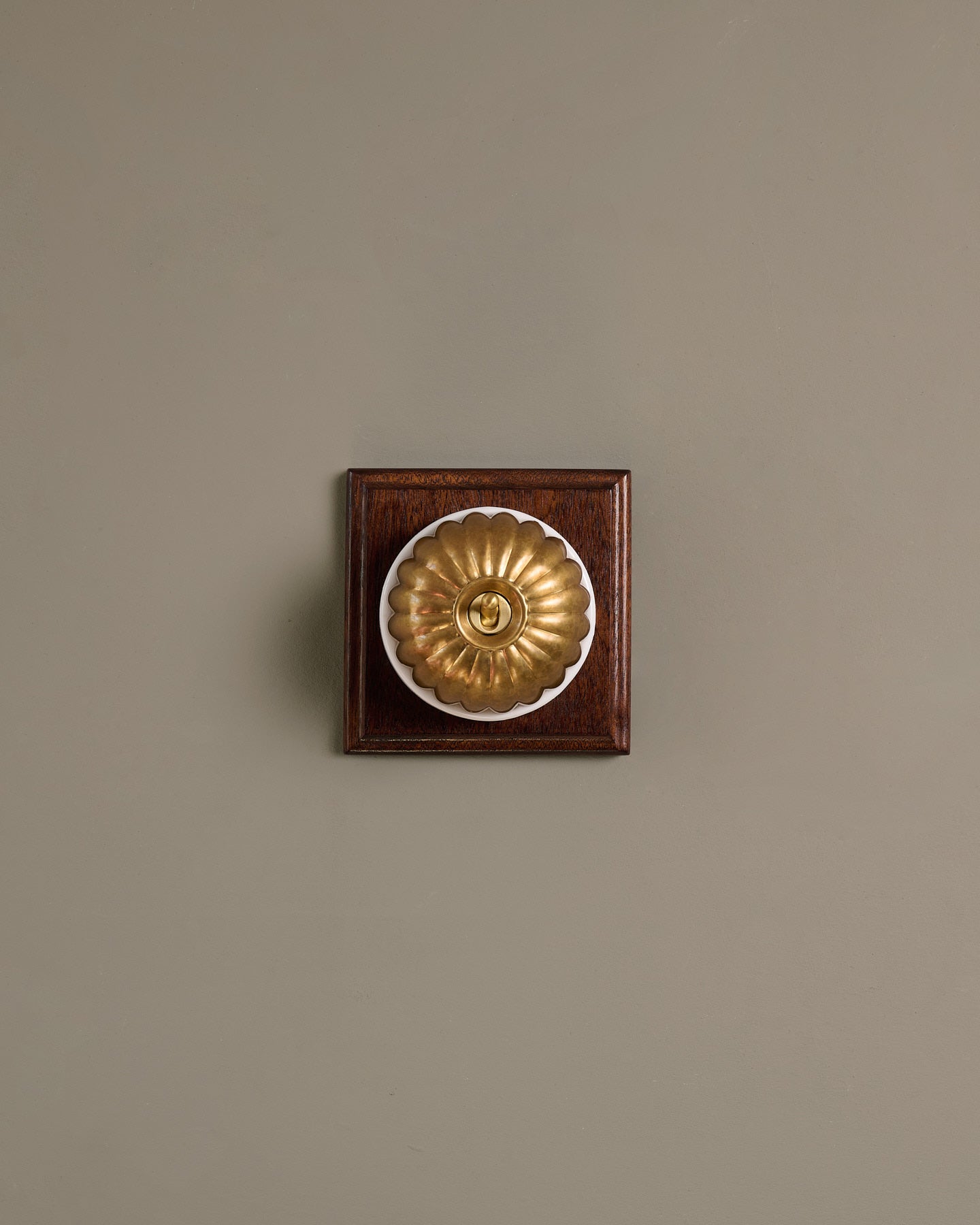 The Jelly Toggle Switch (1 Gang & Mahogany Finish Pattress) - Aged Brass with White Base.