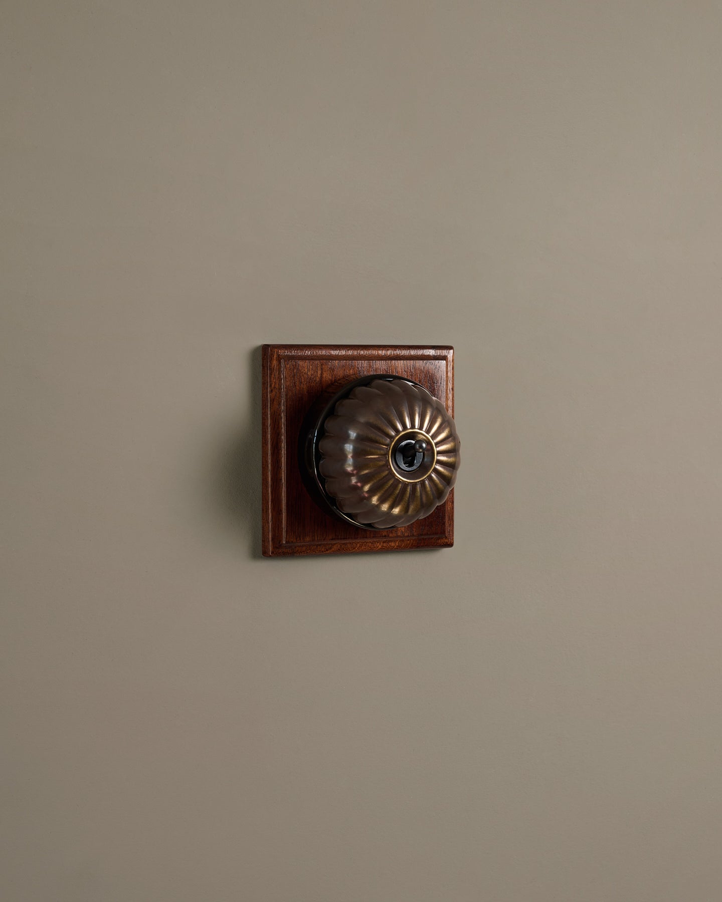 The Jelly Toggle Switch (1 Gang & Mahogany Finish Pattress) - Oxidised Brass with Black Base.