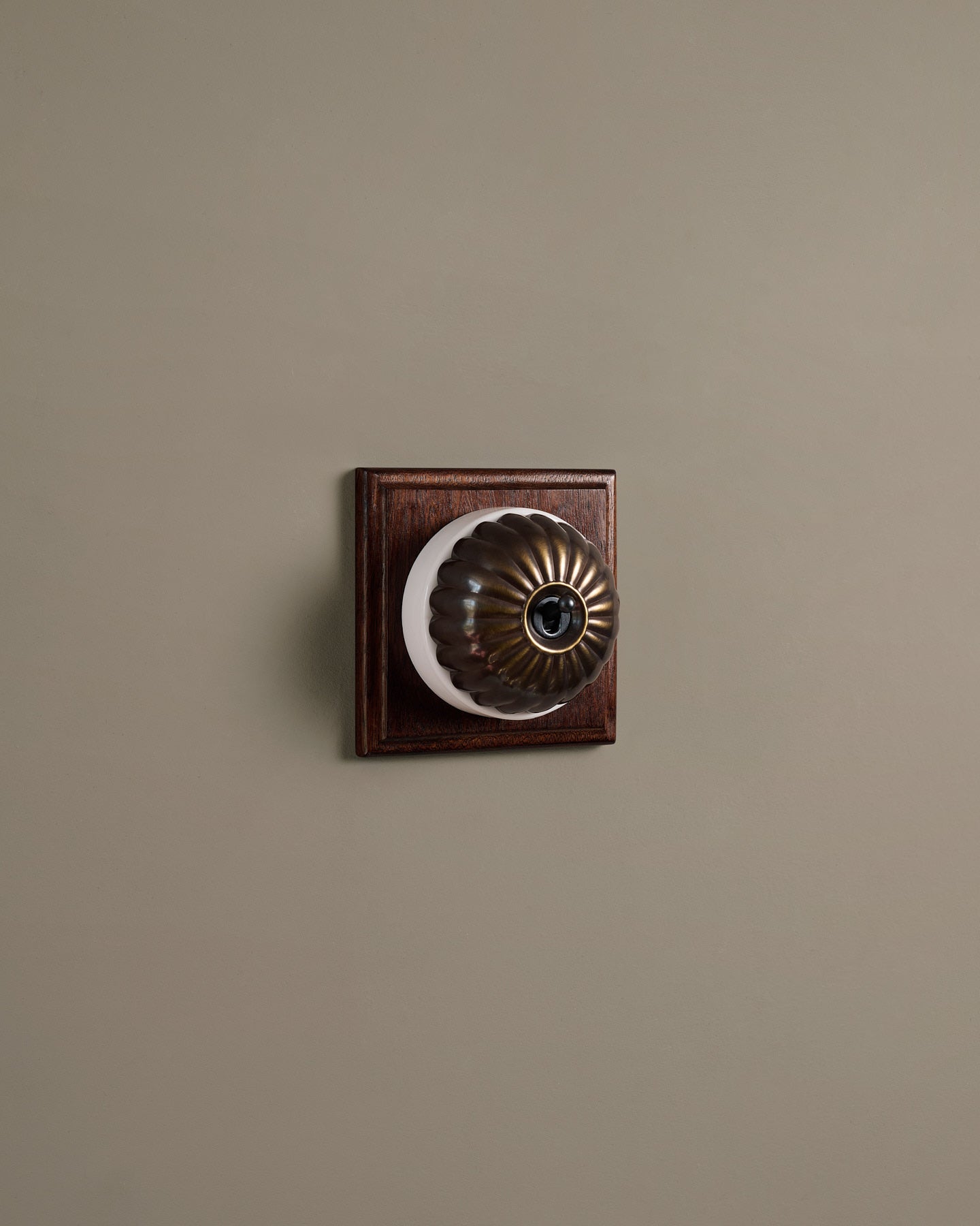 The Jelly Toggle Switch (1 Gang & Mahogany Finish Pattress) - Oxidised Brass with White Base.