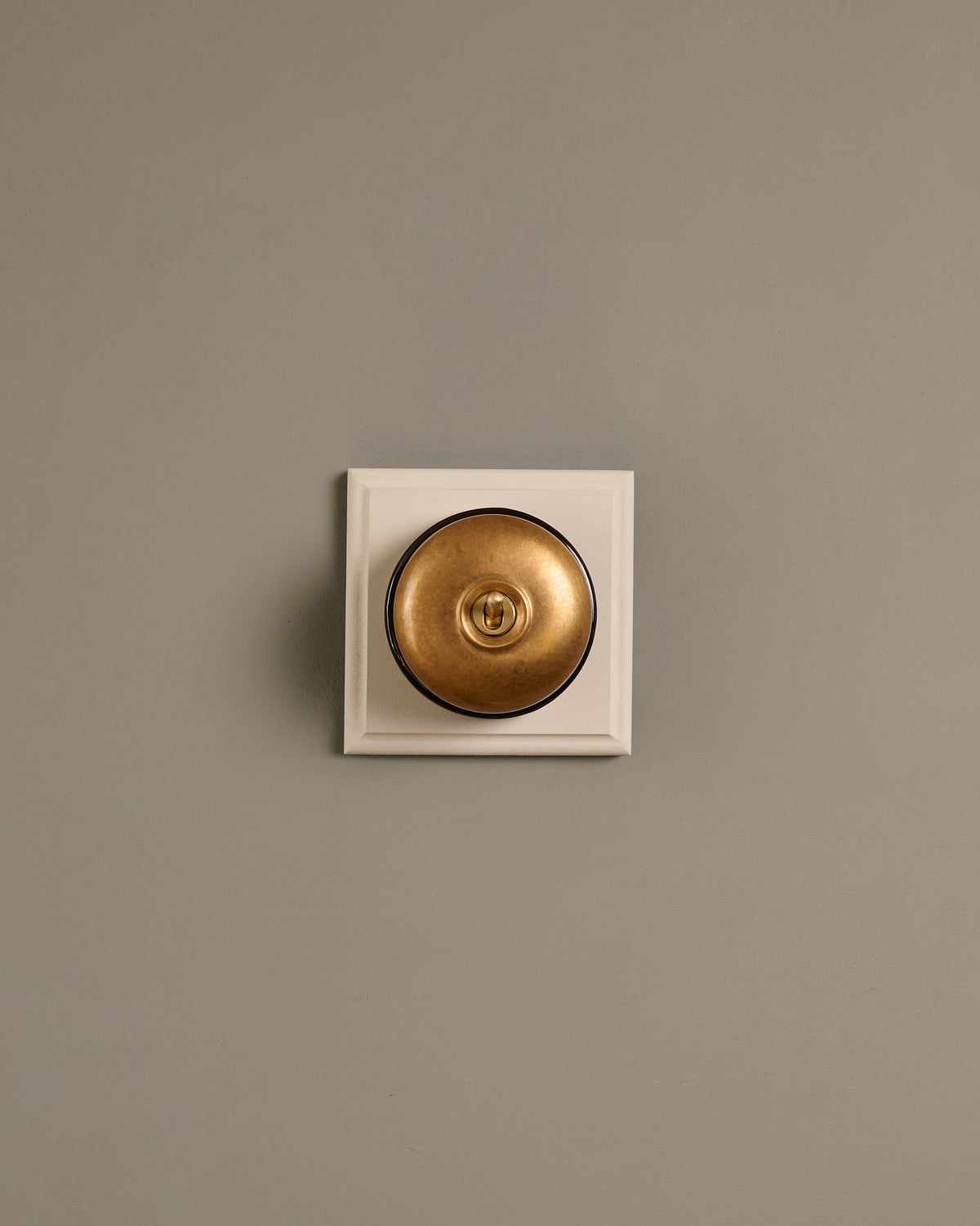 The Dolly Toggle Switch (1 Gang & Primed Maple Pattress) - Aged Brass with Black Base. TEST
