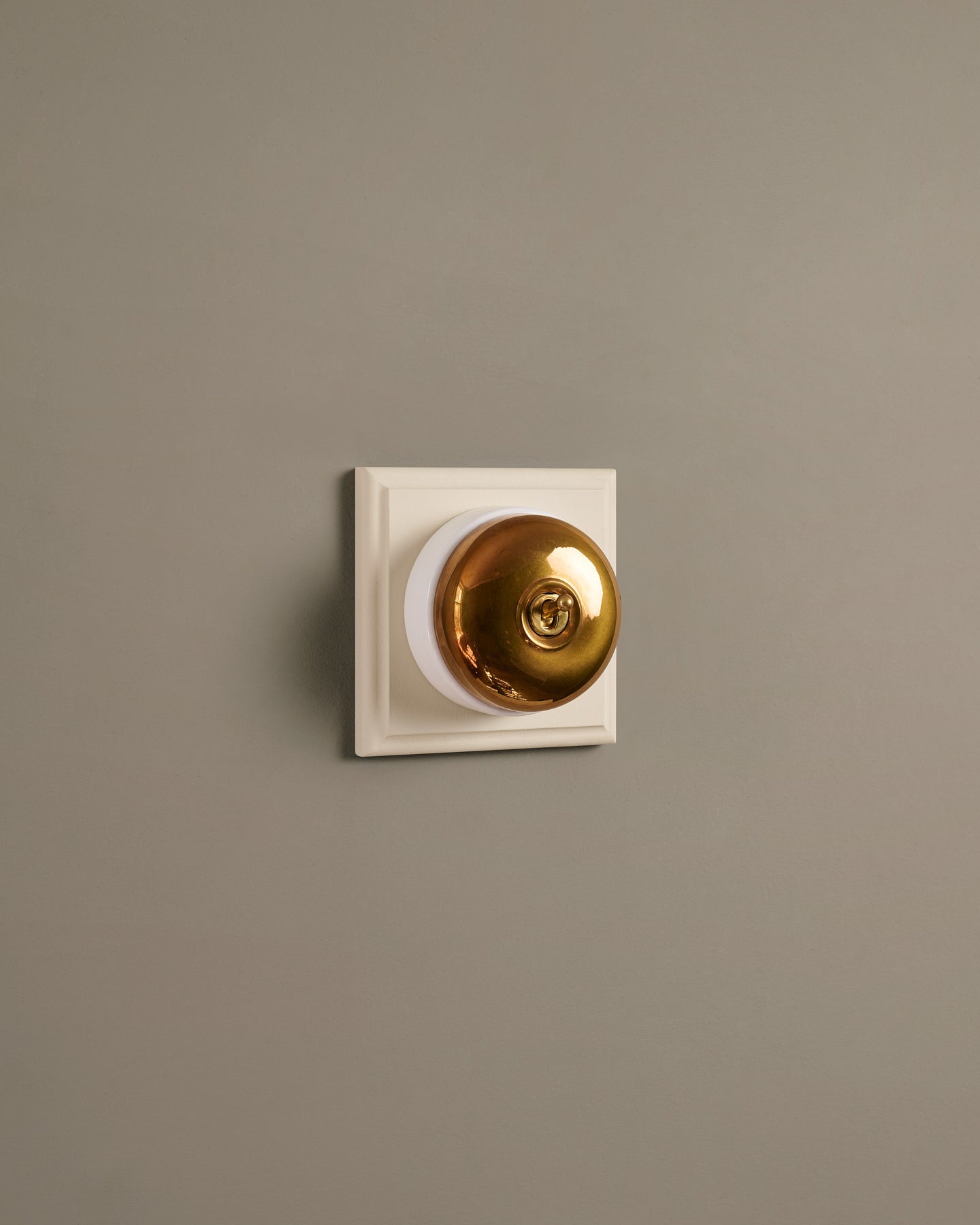 The Dolly Toggle Switch (1 Gang & Primed Maple Pattress) - Heirloom Brass with White Base.