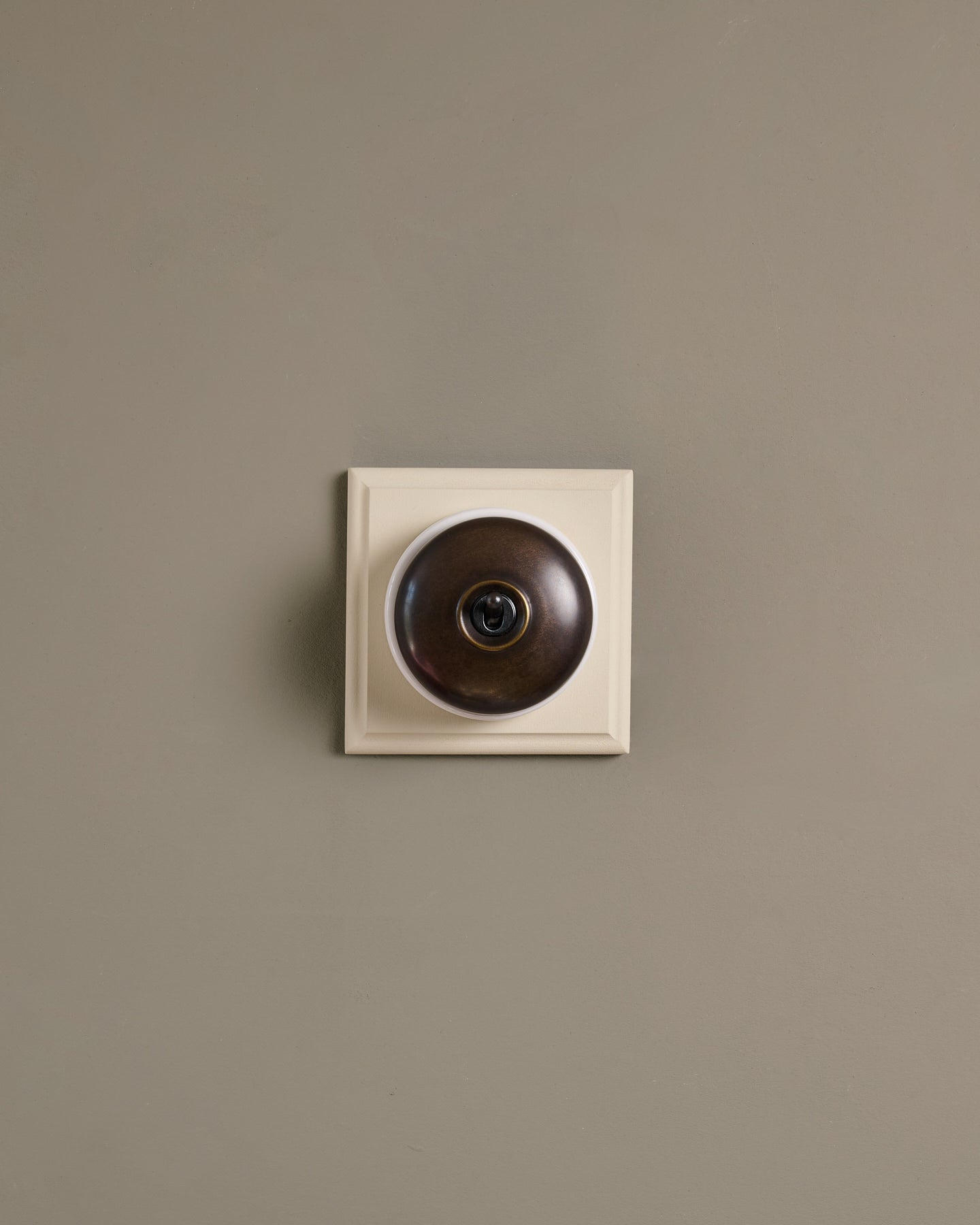 The Dolly Toggle Switch (1 Gang & Primed Maple Pattress) - Oxidised Brass with White Base.