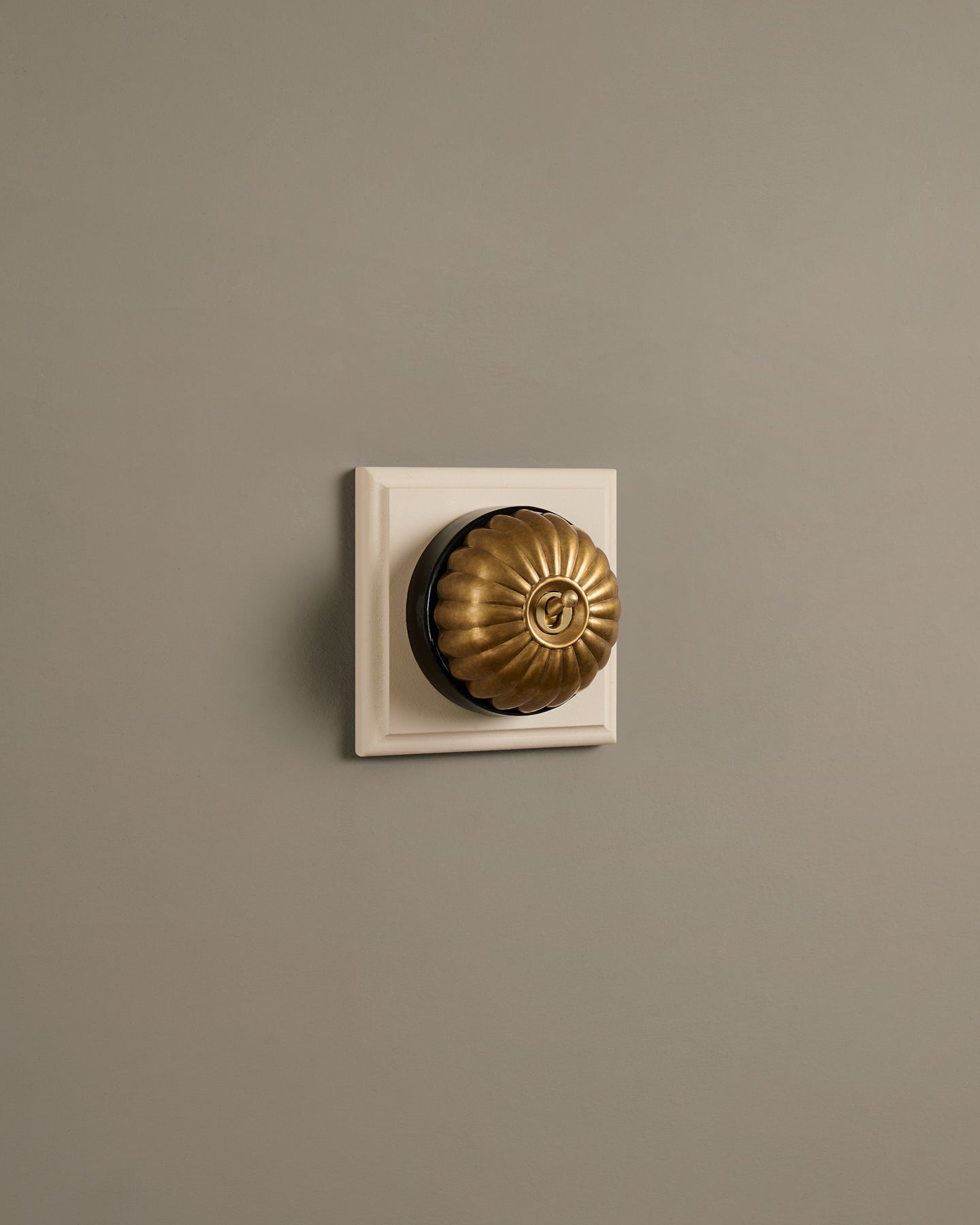 The Jelly Toggle Switch (1 Gang & Primed Maple Pattress) - Aged Brass with Black Base.