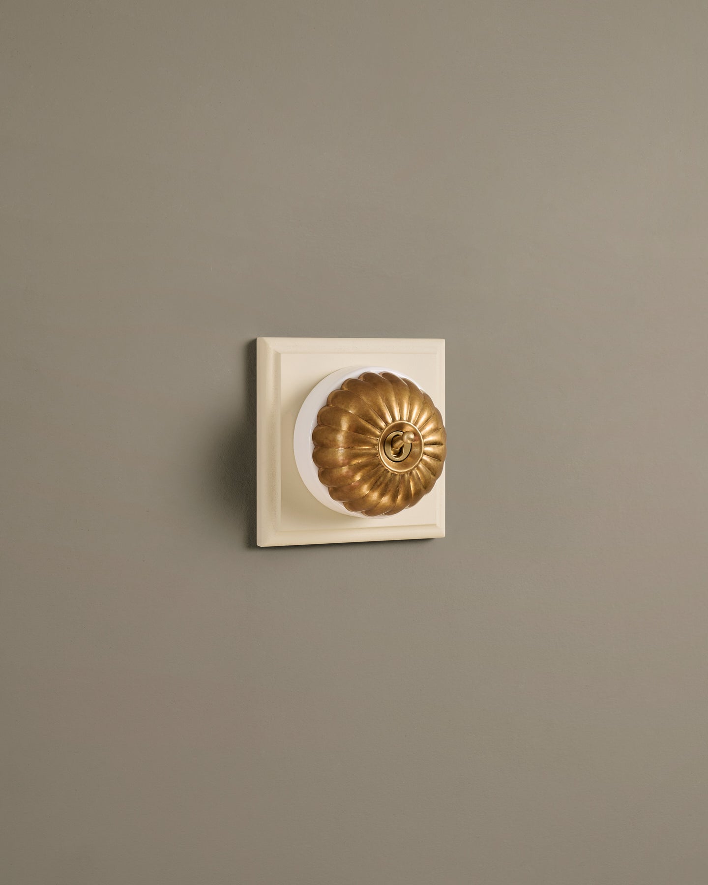 The Jelly Toggle Switch (1 Gang & Primed Maple Pattress) - Aged Brass with White Base.