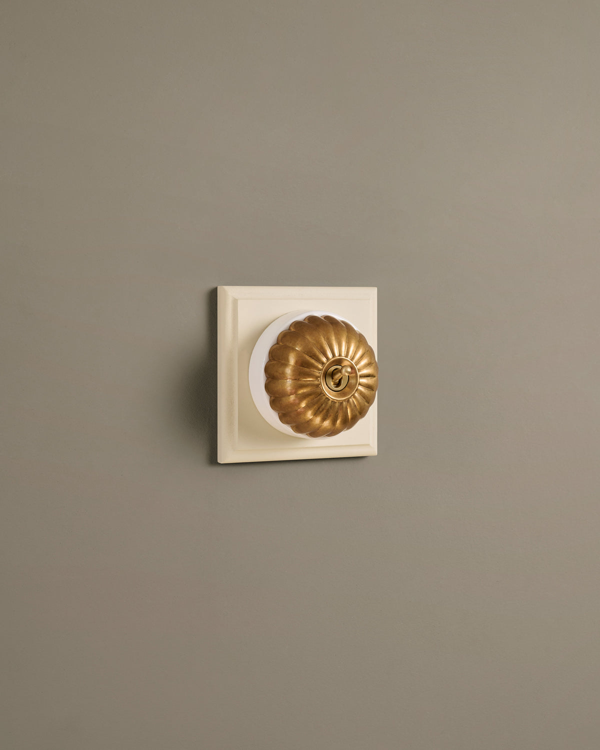The Jelly Toggle Switch (1 Gang & Primed Maple Pattress) - Aged Brass with White Base. TEST