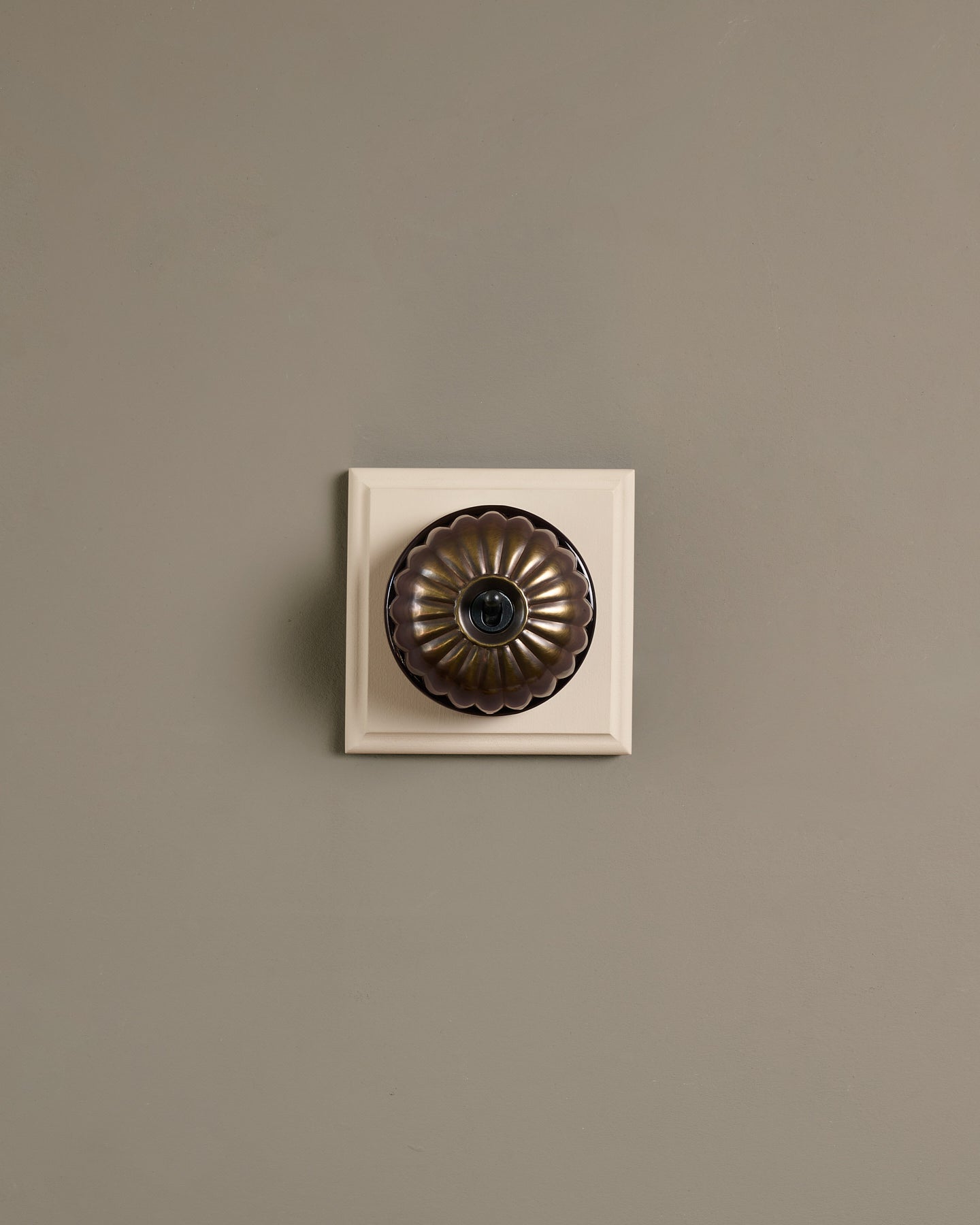 The Jelly Toggle Switch (1 Gang & Primed Maple Pattress) - Oxidised Brass with Black Base.