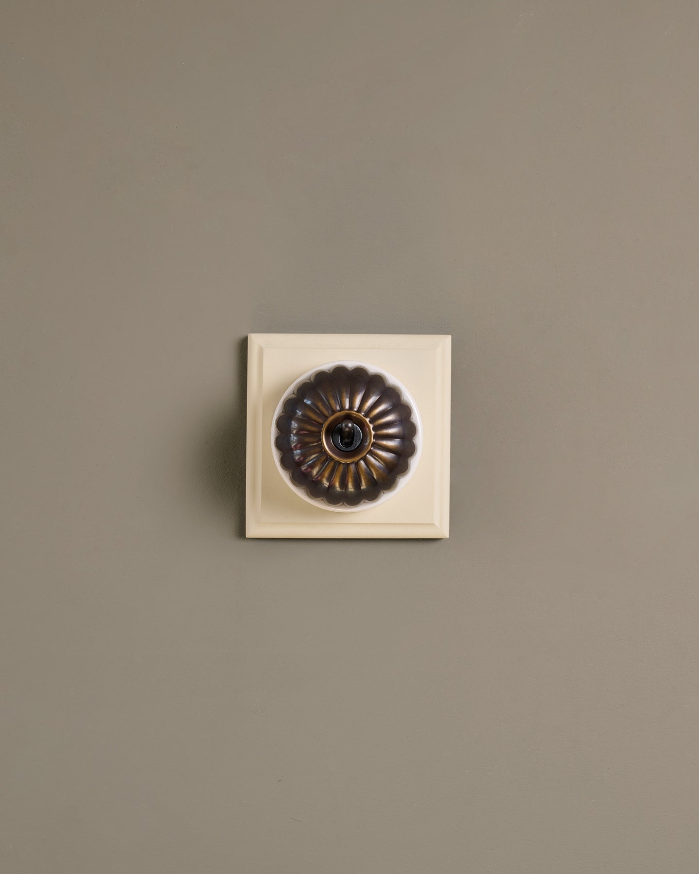 The Jelly Toggle Switch (1 Gang & Primed Maple Pattress) - Oxidised Brass with White Base.
