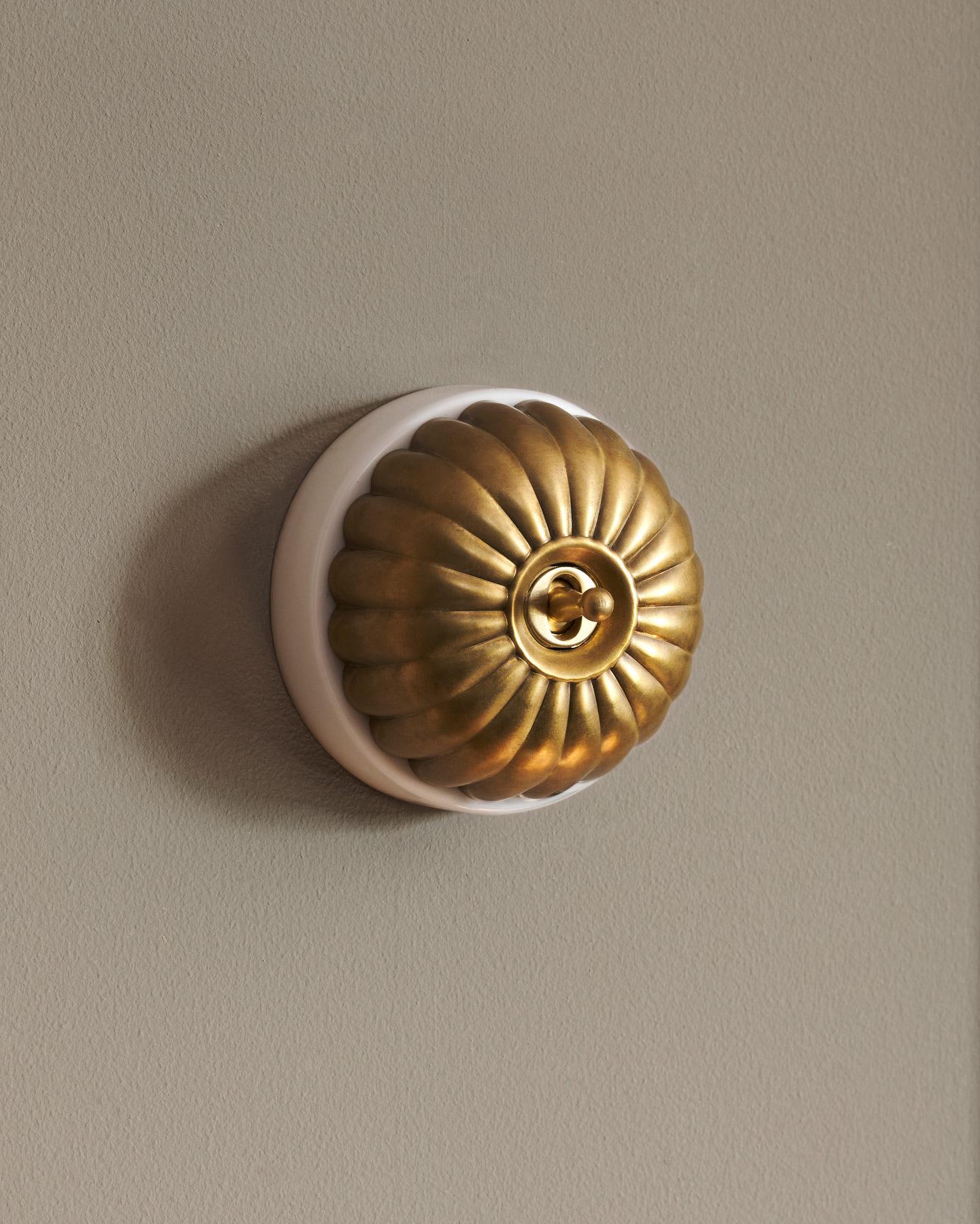 The Jelly Toggle Switch - Aged Brass, White Base, Retract to Centre