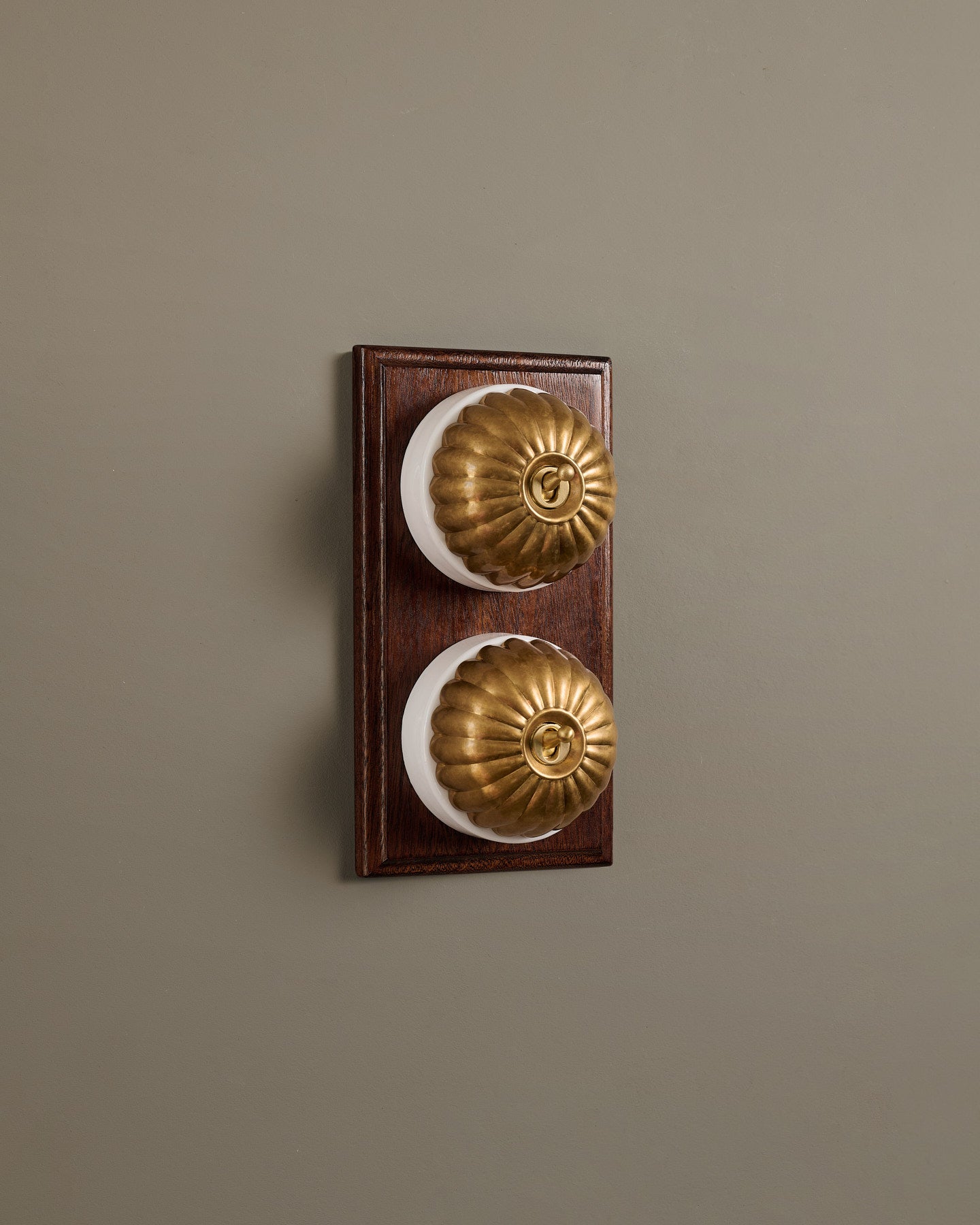 The Jelly Toggle Switch (2 Gang & Mahogany Finish Pattress) - Aged Brass with White Base.