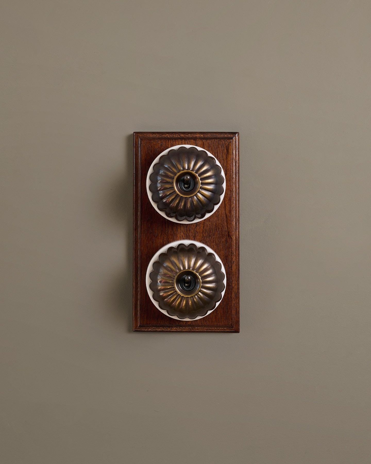 The Jelly Toggle Switch (2 Gang & Mahogany Finish Pattress) - Oxidised Brass with White Base.