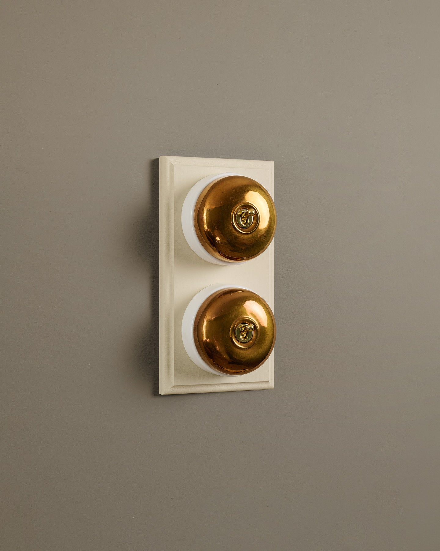 The Dolly Toggle Switch (2 Gang & Primed Maple Pattress) - Heirloom Brass with White Base.