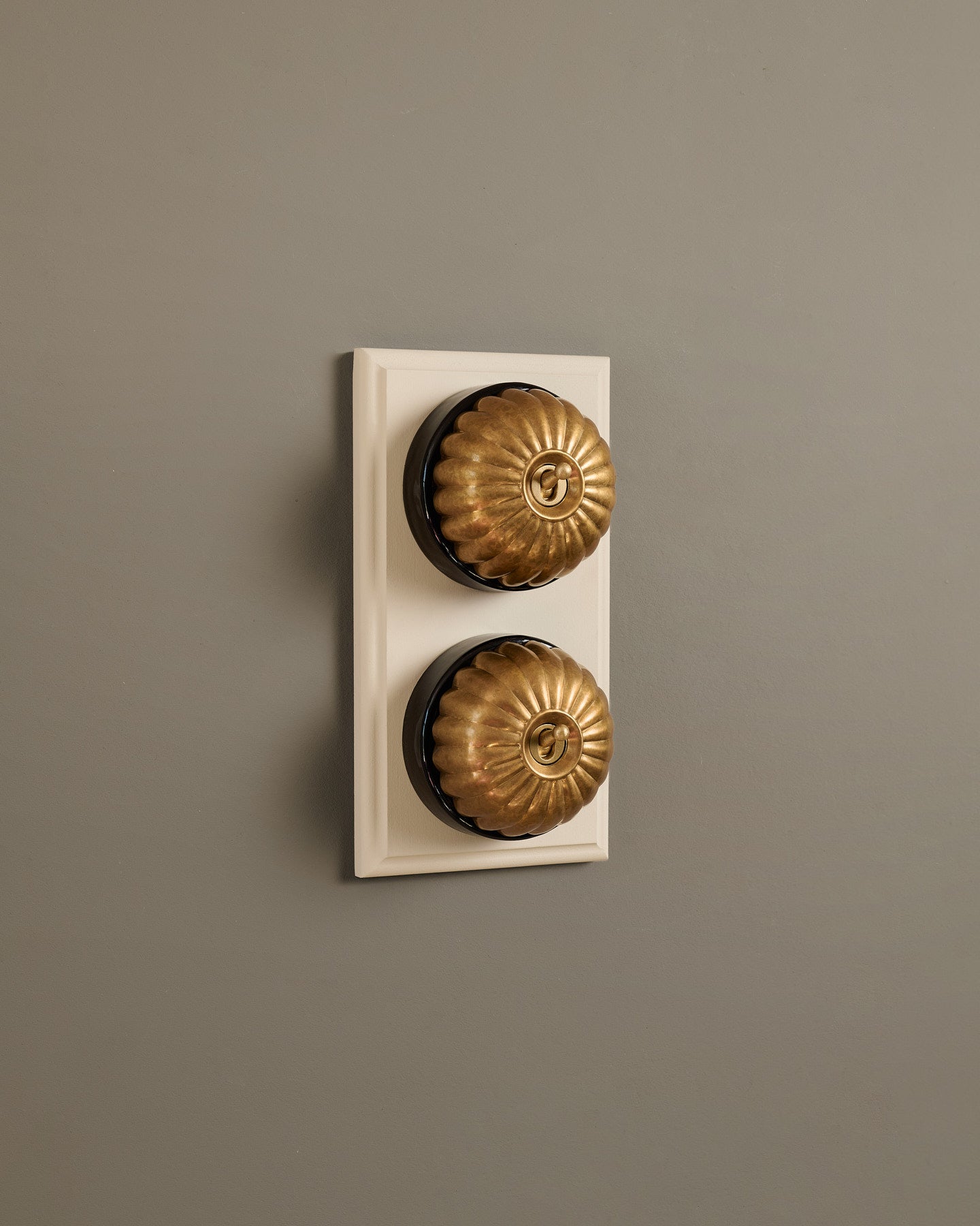 The Jelly Toggle Switch (2 Gang & Primed Maple Pattress) - Aged Brass with Black Base.