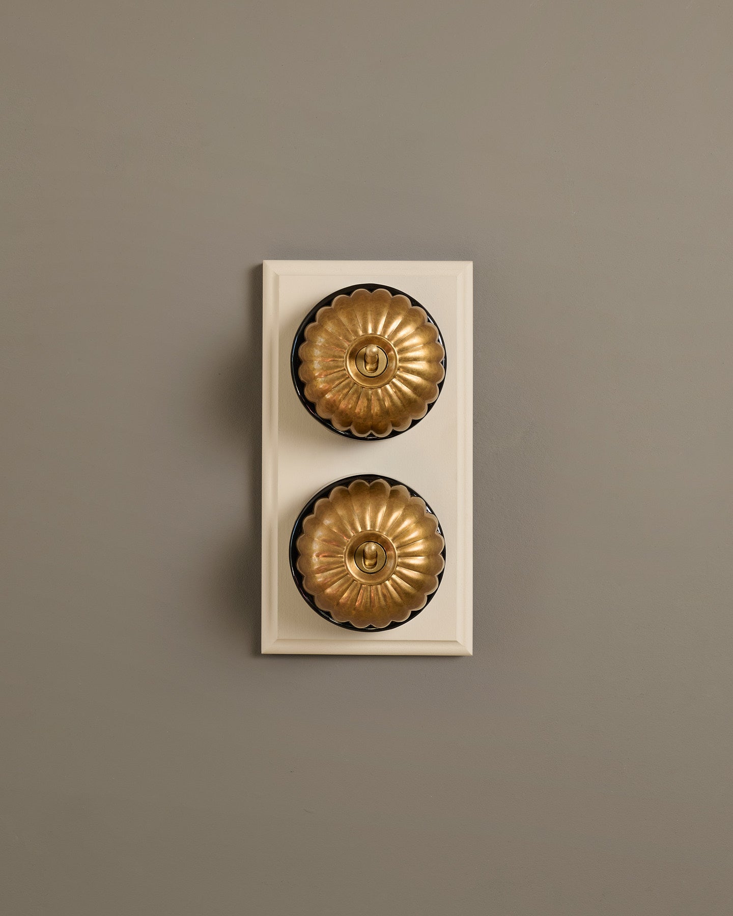 The Jelly Toggle Switch (2 Gang & Primed Maple Pattress) - Aged Brass with Black Base.