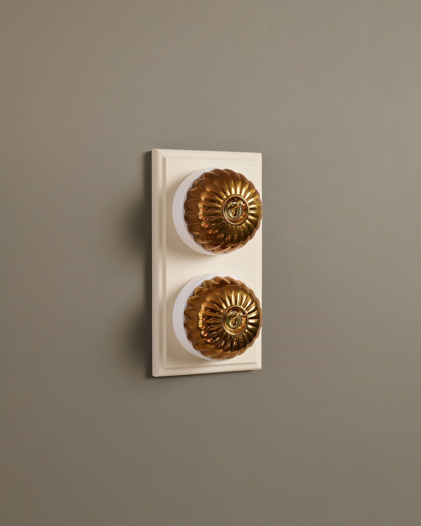 The Jelly Toggle Switch (2 Gang & Primed Maple Pattress) - Heirloom Brass with White Base.