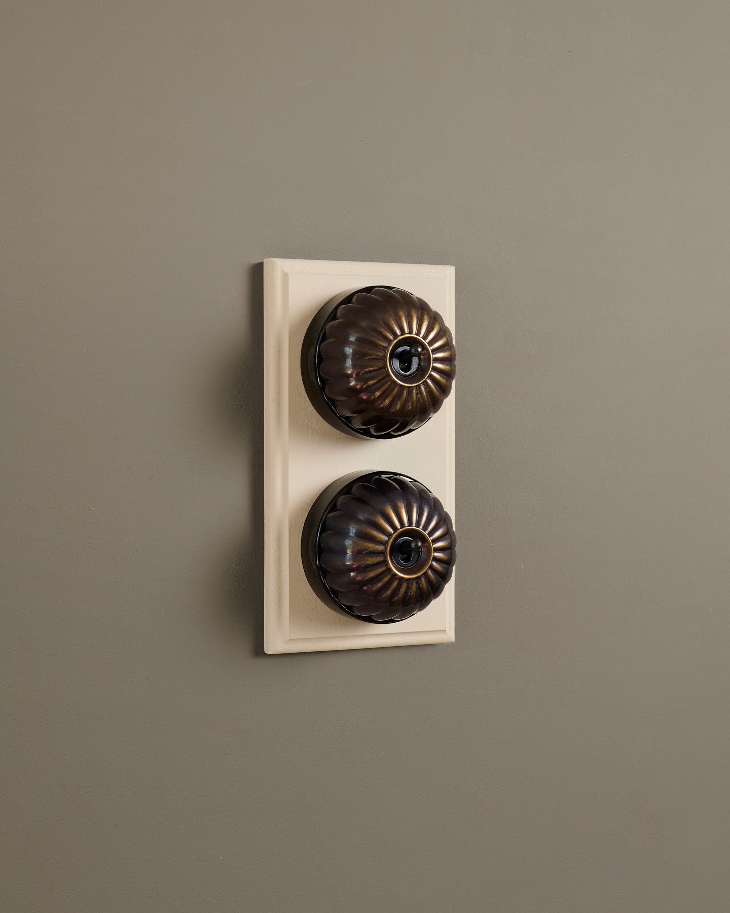 The Jelly Toggle Switch (2 Gang & Primed Maple Pattress) - Oxidised Brass with Black Base.