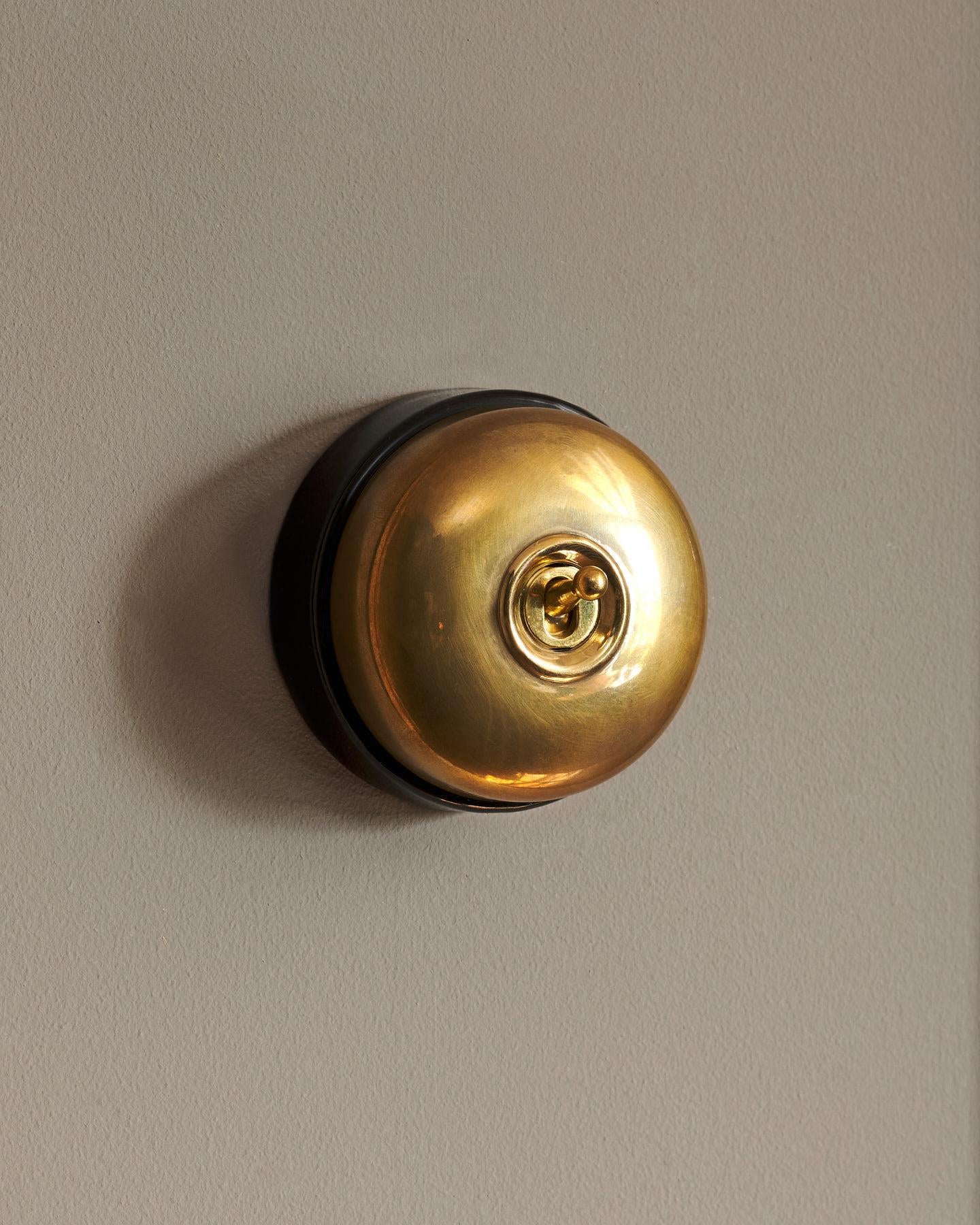 The Dolly Toggle Switch - Heirloom Brass, Black Base, Single Way Retract