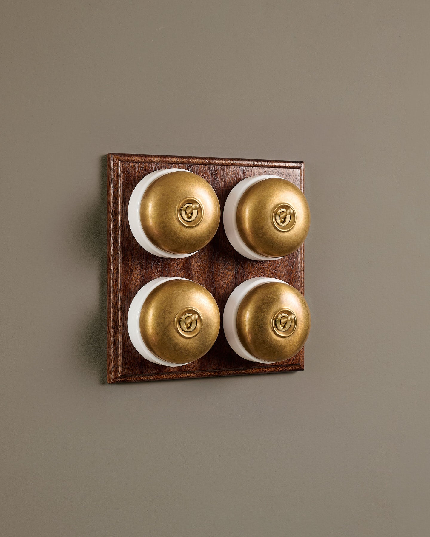 The Dolly Toggle Switch (4 Gang Bank & Mahogany Finish Pattress) - Aged Brass with White Base.