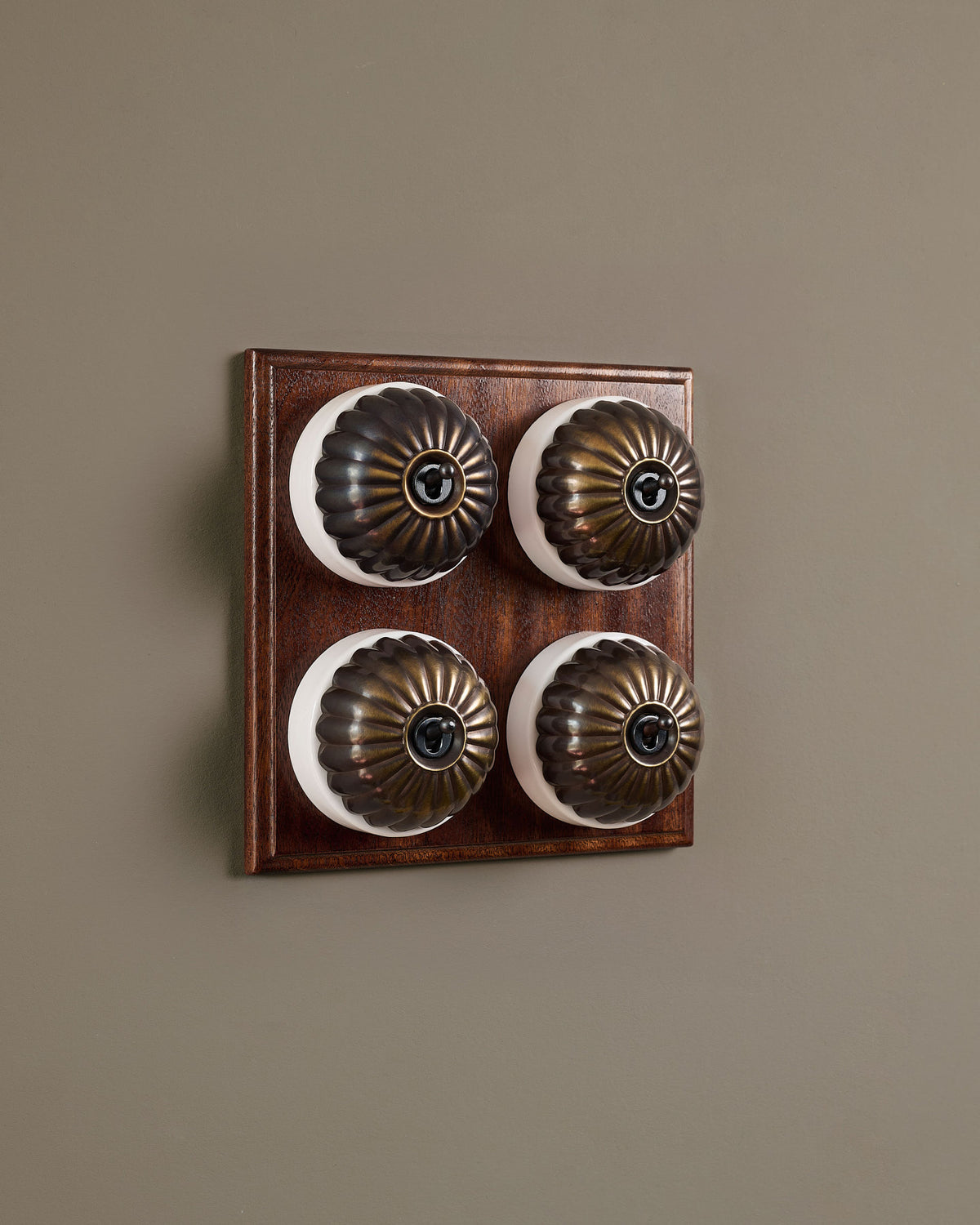 The Jelly Toggle Switch (4 Gang Bank & Mahogany Finish Pattress) - Oxidised Brass with White Base. TEST
