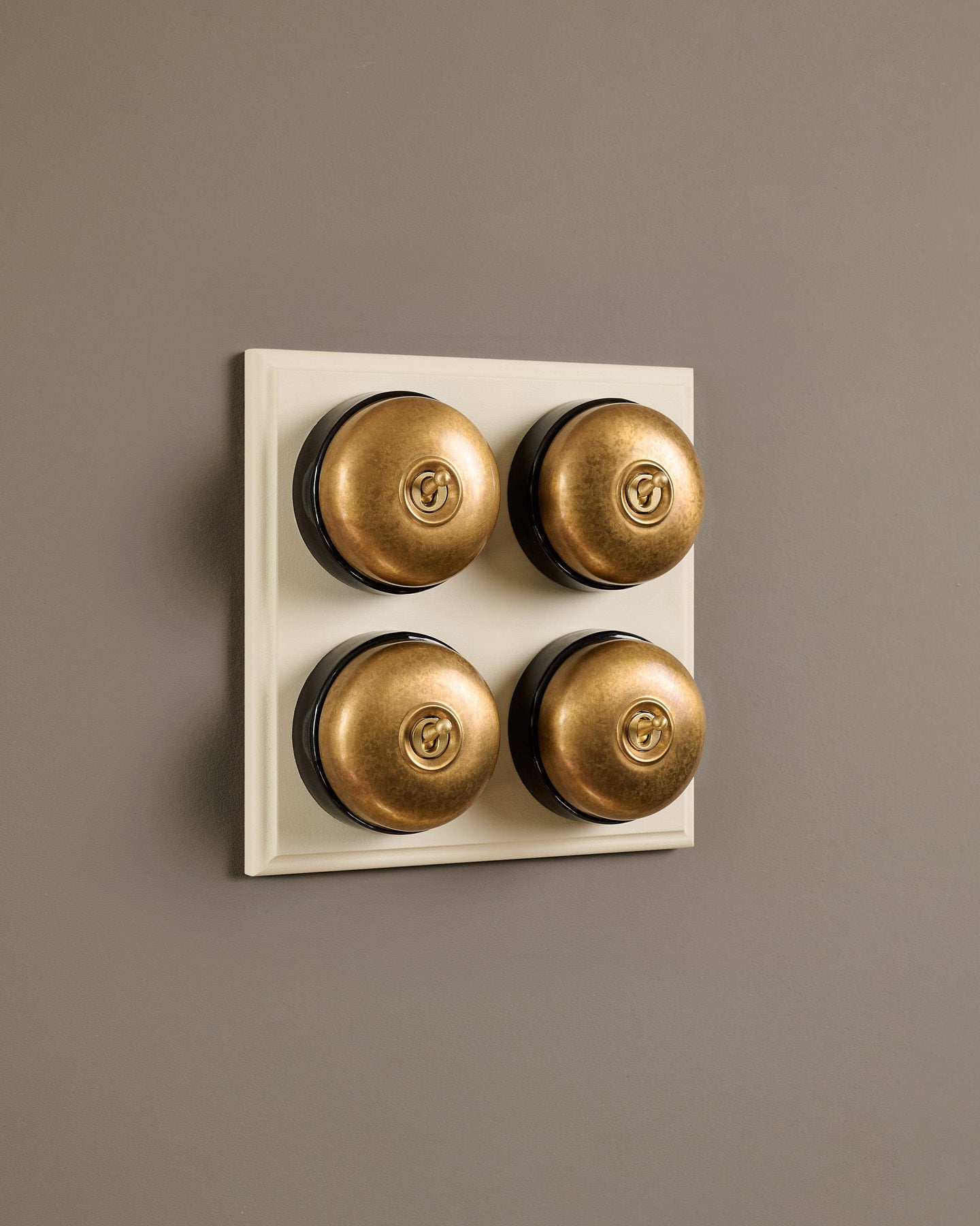 The Dolly Toggle Switch (4 Gang Bank & Primed Maple Pattress) - Aged Brass with Black Base.