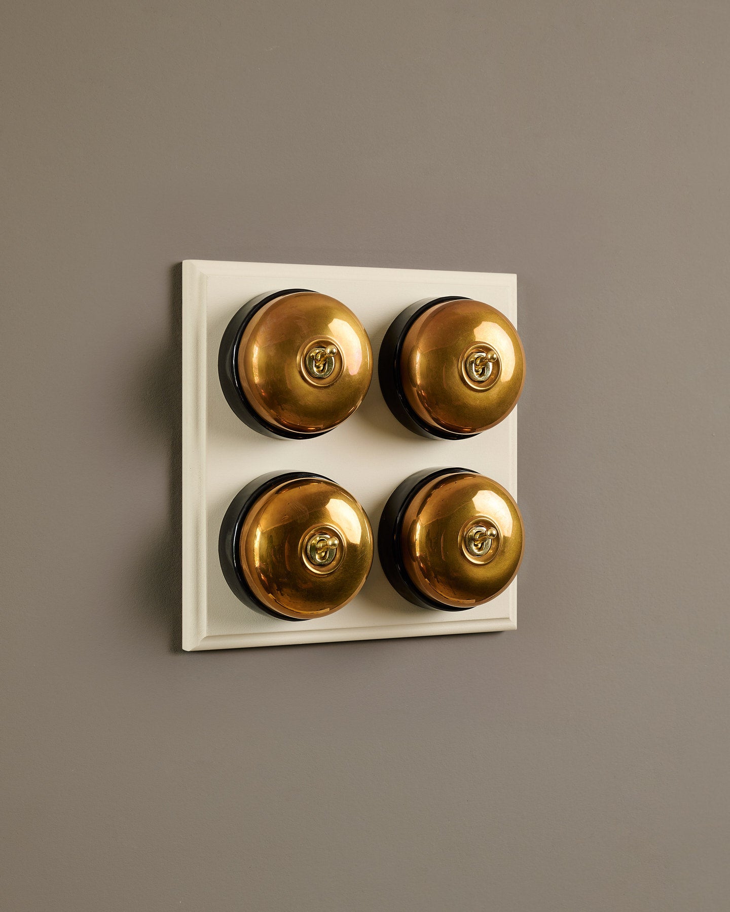 The Dolly Toggle Switch (4 Gang Bank & Primed Maple Pattress) - Heirloom Brass with Black Base.
