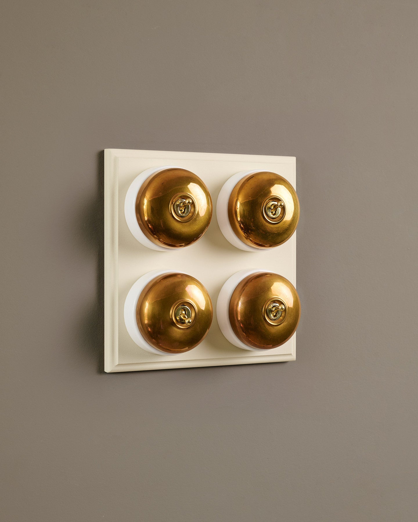 The Dolly Toggle Switch (4 Gang Bank & Primed Maple Pattress) - Heirloom Brass with White Base.