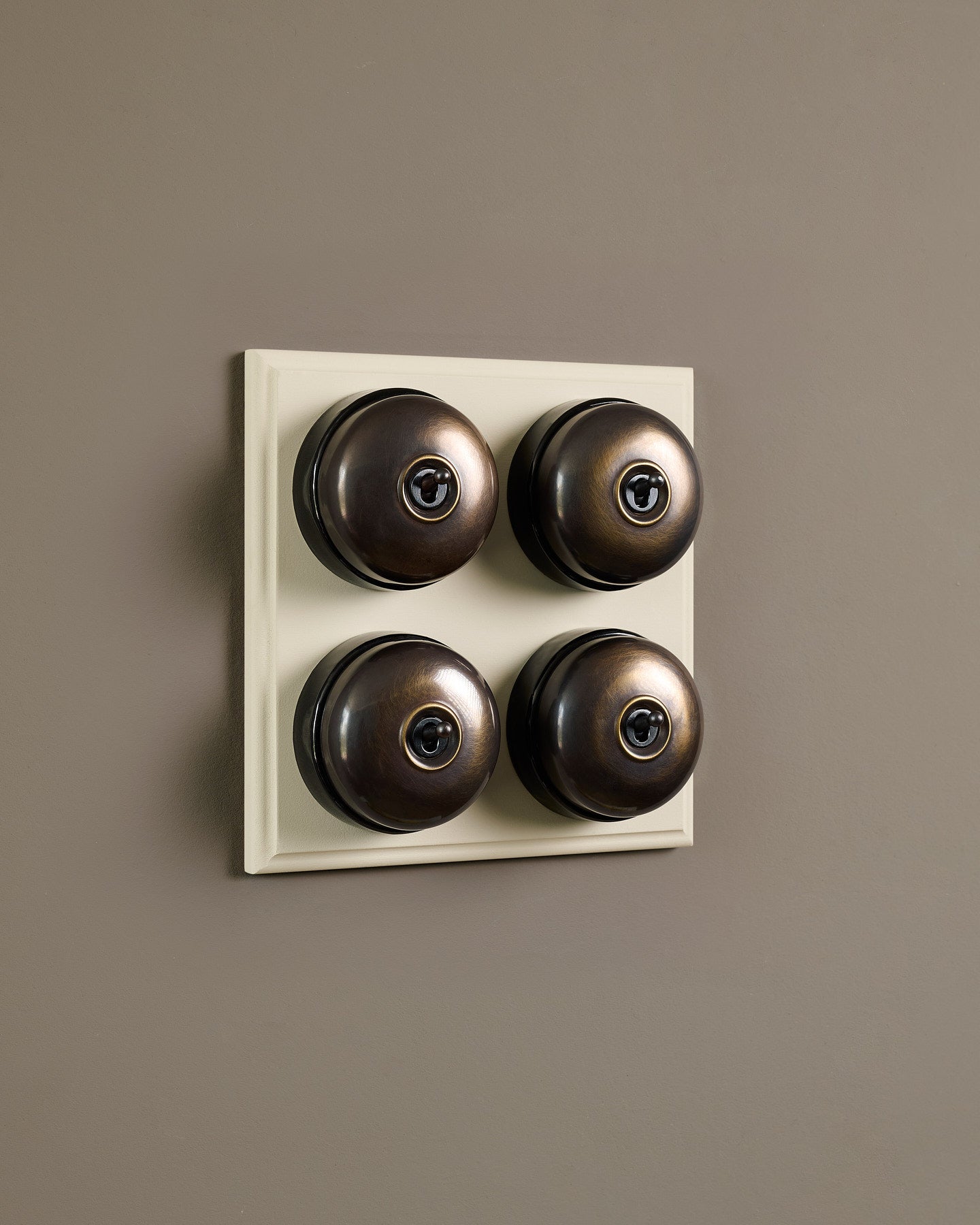 The Dolly Toggle Switch (4 Gang Bank & Primed Maple Pattress) - Oxidised Brass with Black Base.