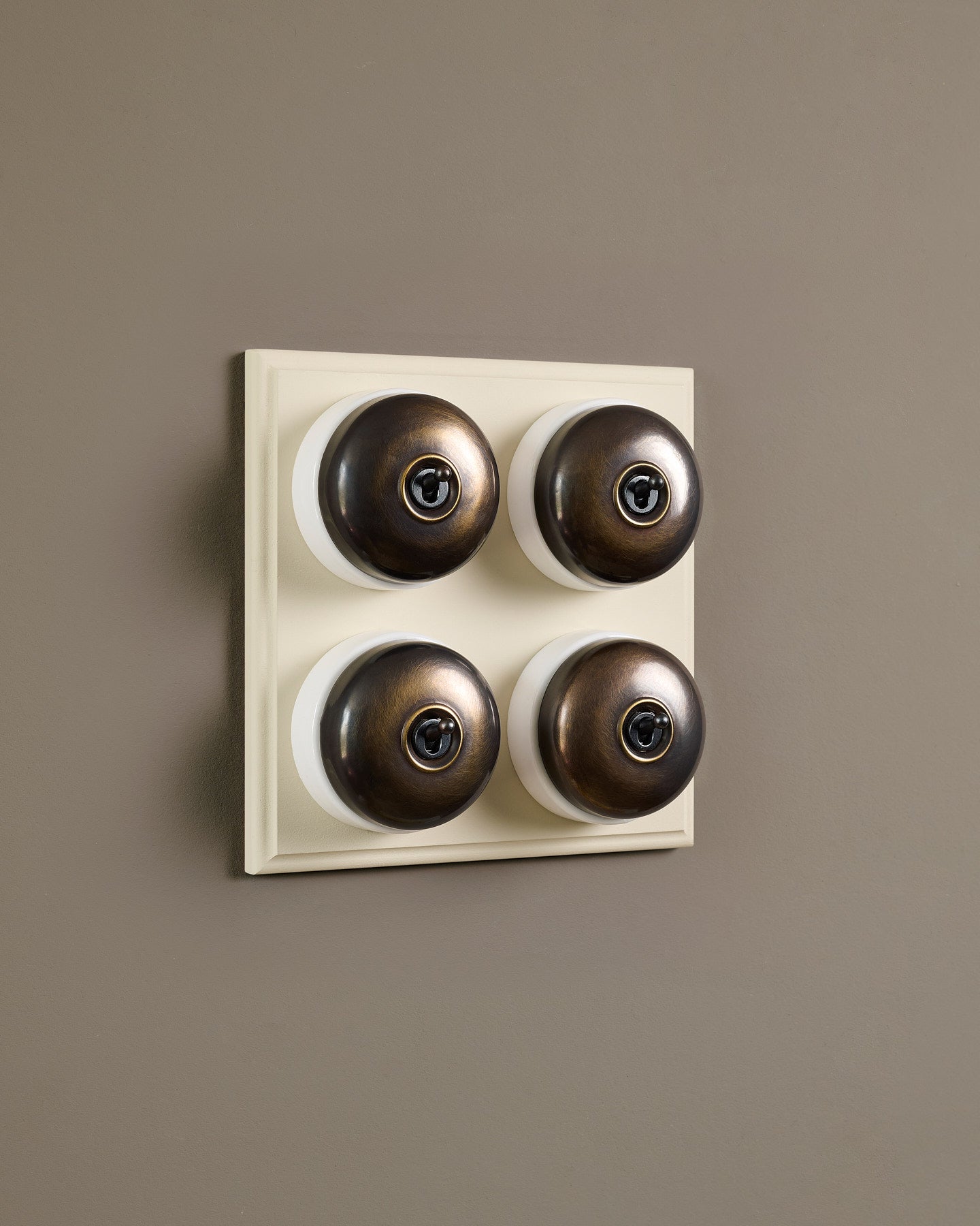The Dolly Toggle Switch (4 Gang Bank & Primed Maple Pattress) - Oxidised Brass with White Base.