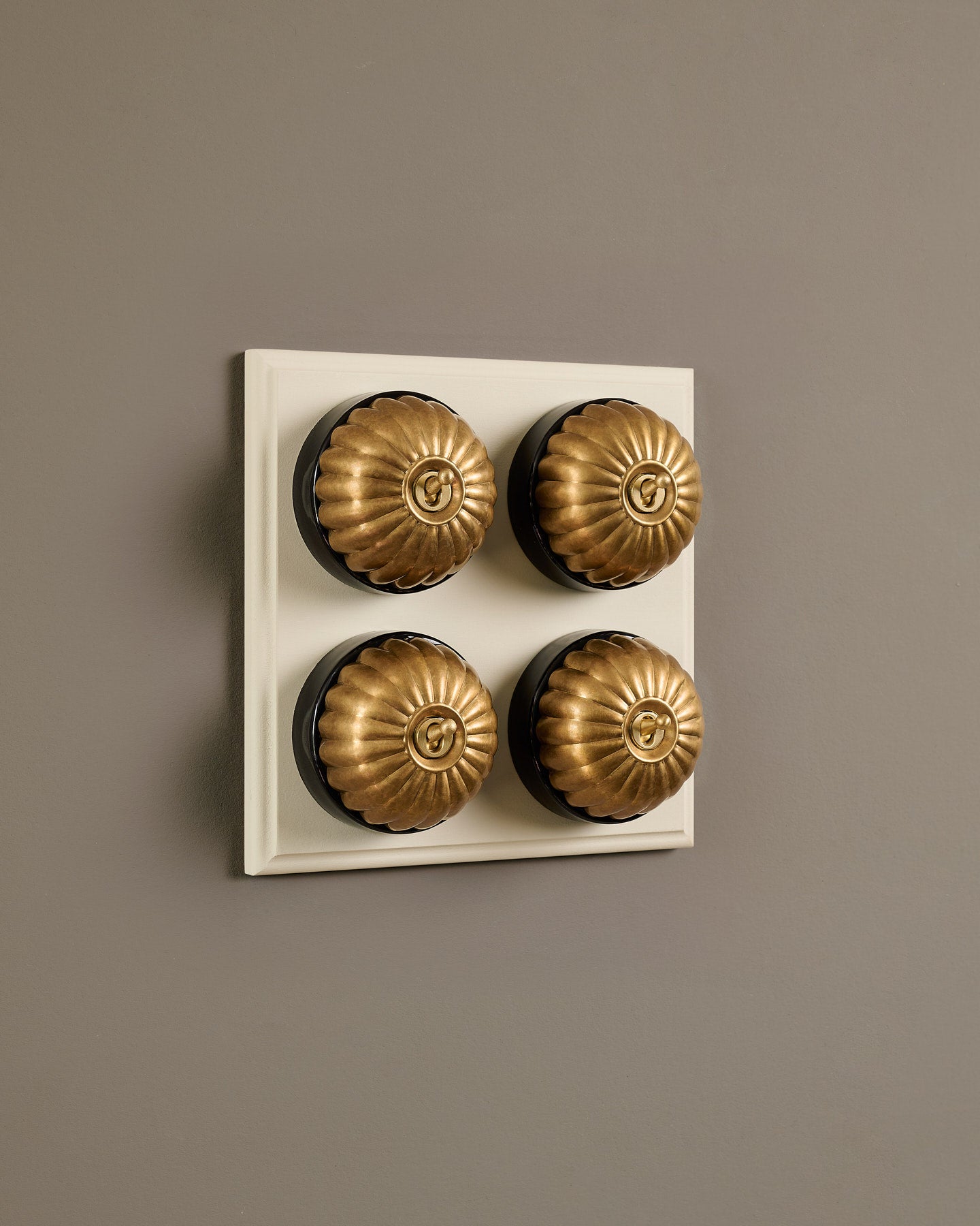 The Jelly Toggle Switch (4 Gang Bank & Primed Maple Pattress) - Aged Brass with Black Base.