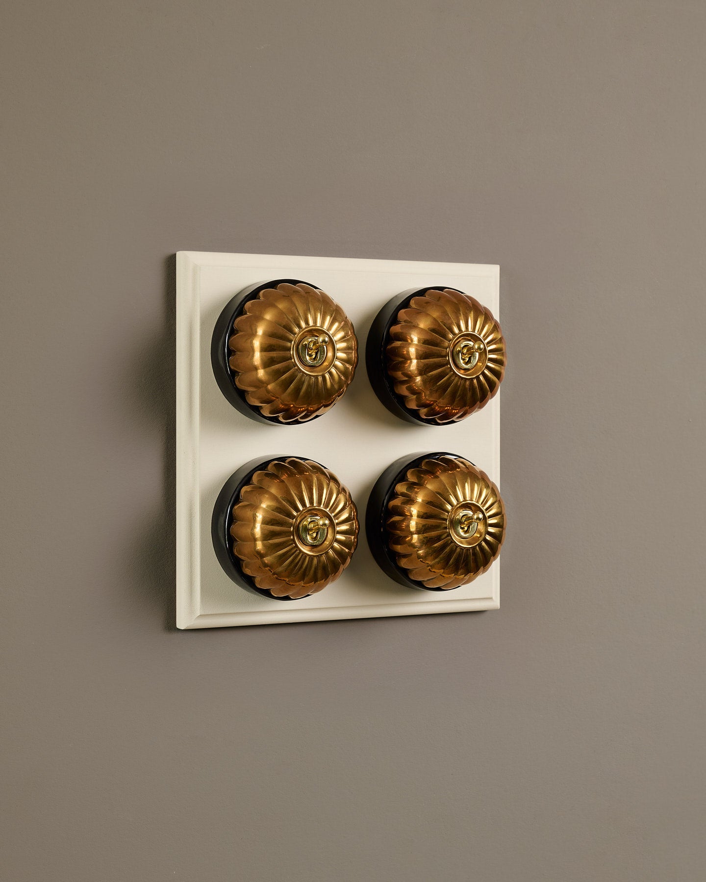 The Jelly Toggle Switch (4 Gang Bank & Primed Maple Pattress) - Heirloom Brass with Black Base.