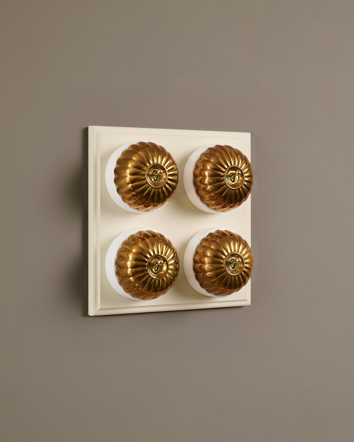 The Jelly Toggle Switch (4 Gang Bank & Primed Maple Pattress) - Heirloom Brass with White Base.