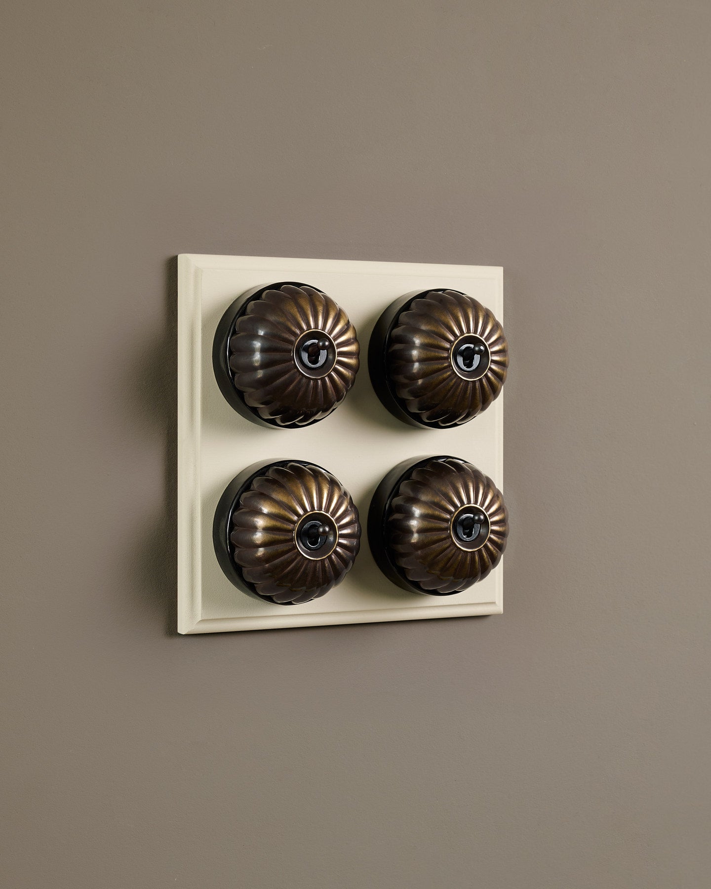 The Jelly Toggle Switch (4 Gang Bank & Primed Maple Pattress) - Oxidised Brass with Black Base.