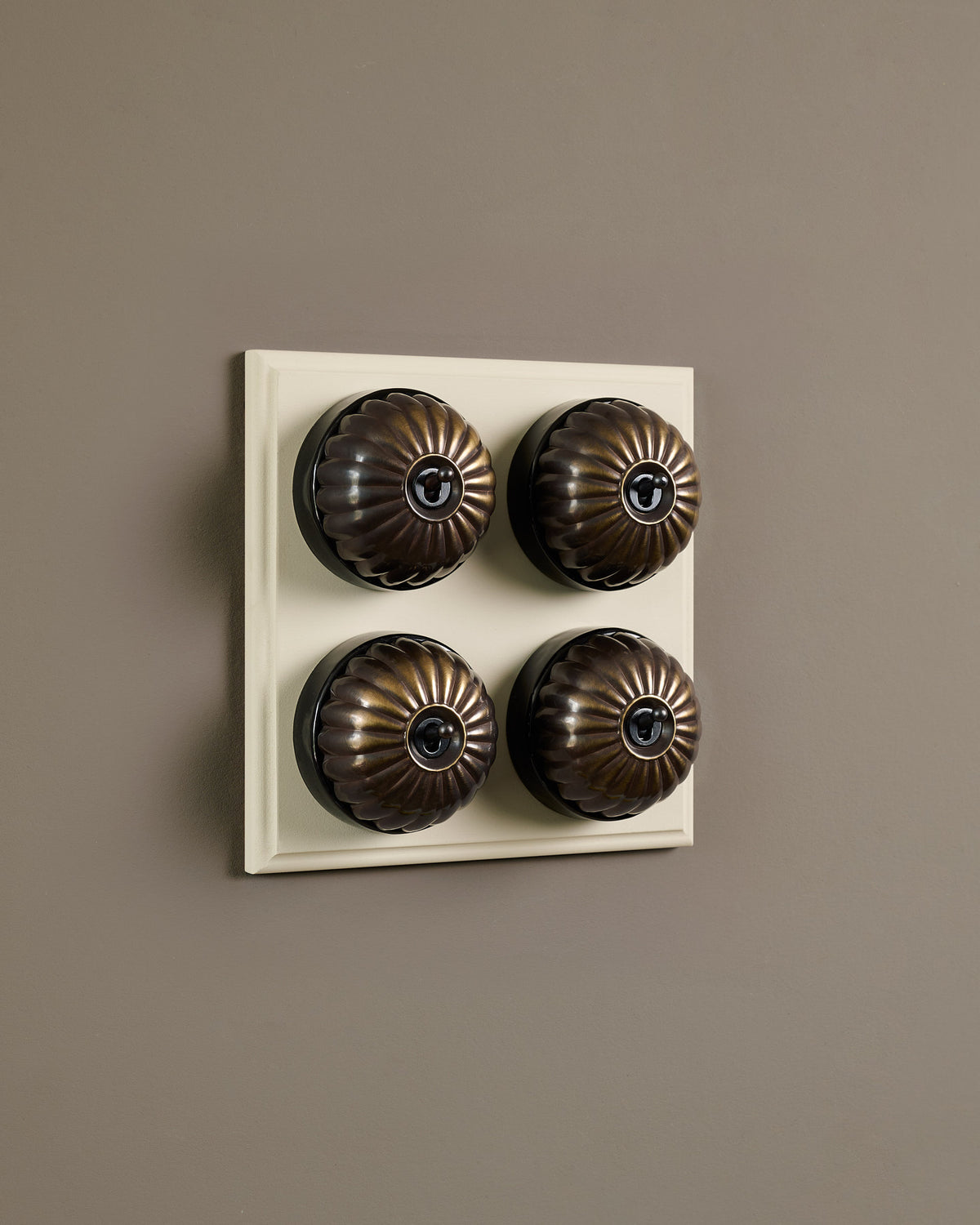 The Jelly Toggle Switch (4 Gang Bank & Primed Maple Pattress) - Oxidised Brass with Black Base. TEST