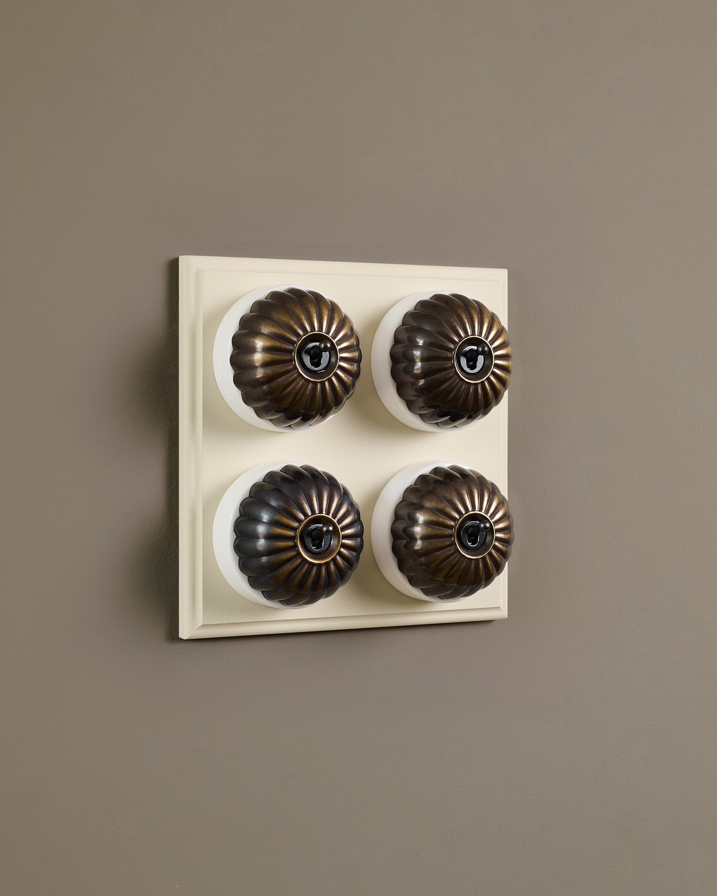 The Jelly Toggle Switch (4 Gang Bank & Primed Maple Pattress) - Oxidised Brass with White Base.