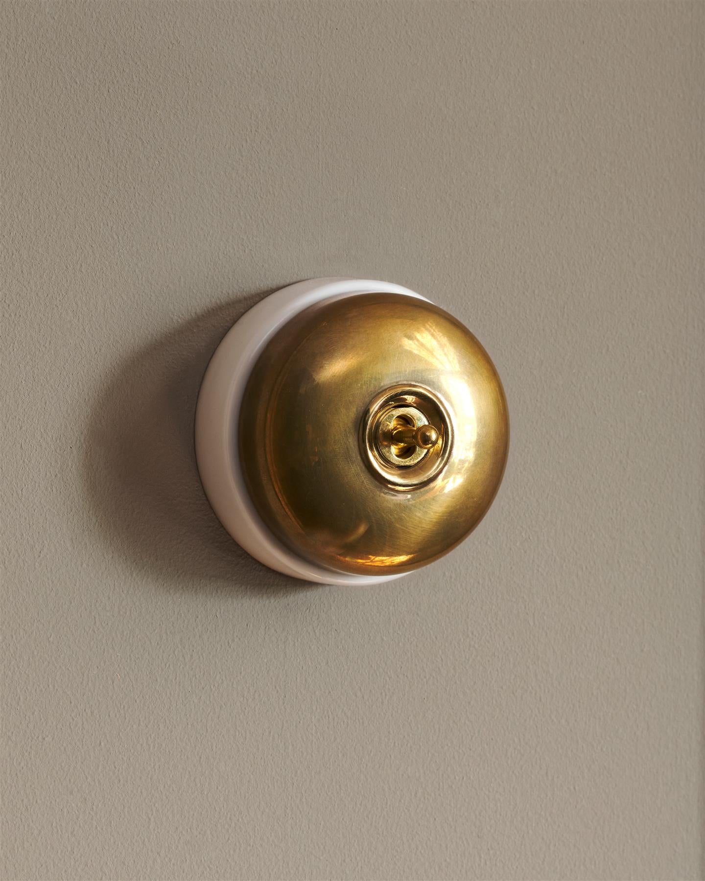 The Dolly Toggle Switch - Heirloom Brass, White Base, Retract to Centre