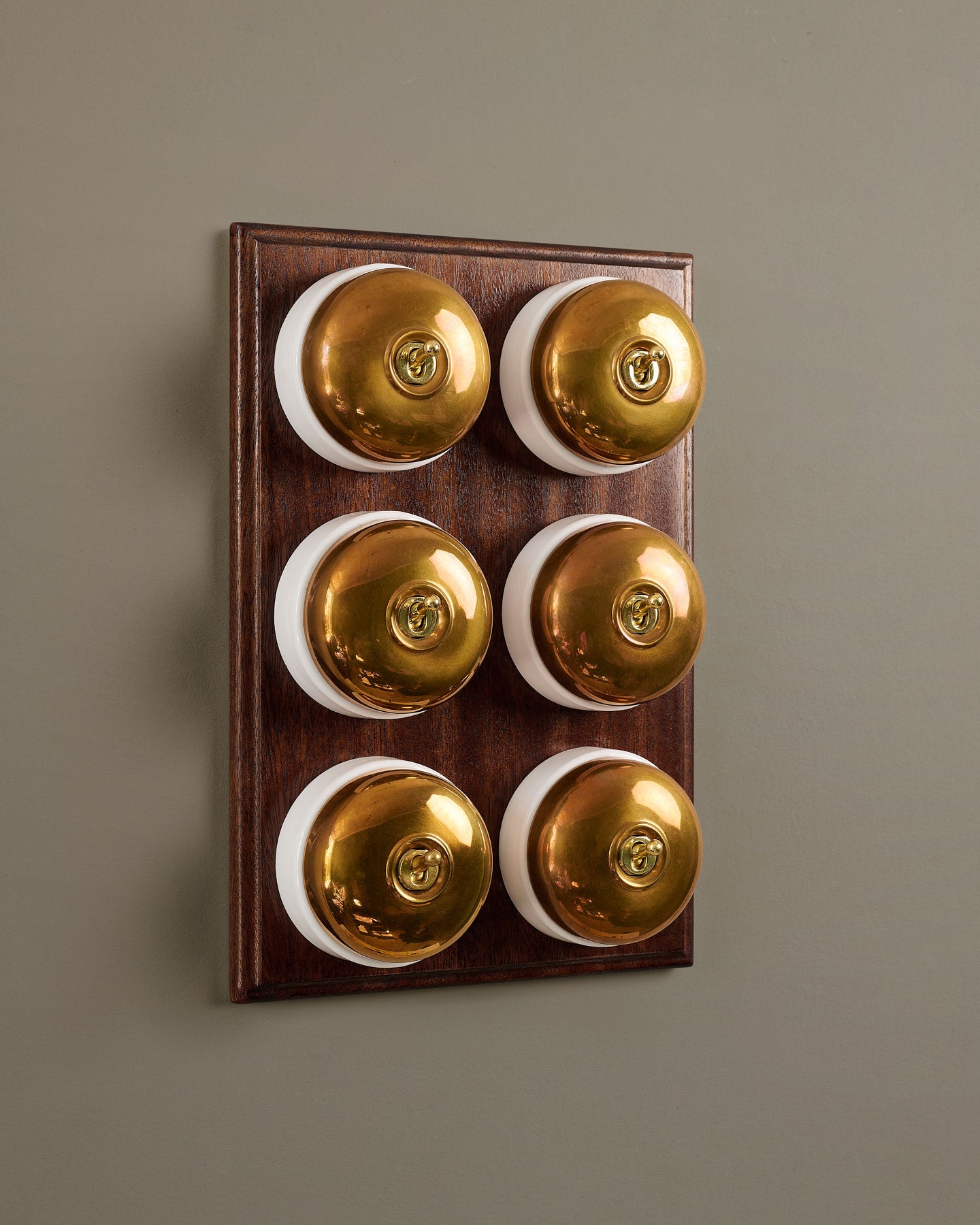 The Dolly Toggle Switch (6 Gang & Mahogany Finish Pattress) - Heirloom Brass with White Base.