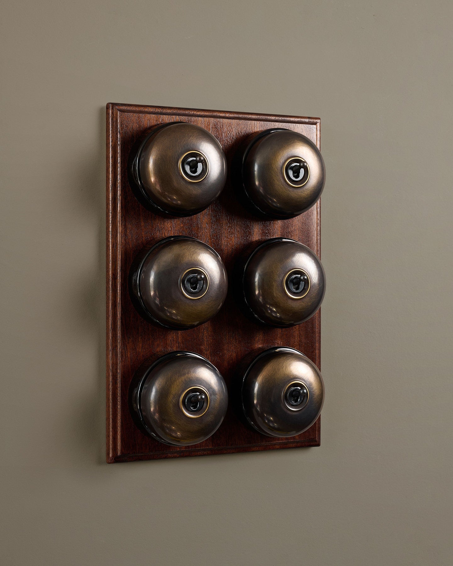 The Dolly Toggle Switch (6 Gang & Mahogany Finish Pattress) - Oxidised Brass with Black Base.