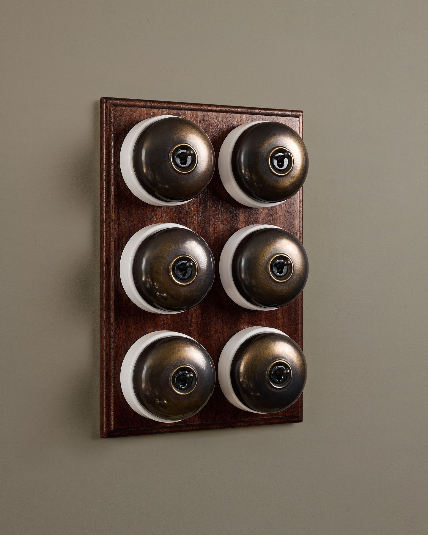 The Dolly Toggle Switch (6 Gang & Mahogany Finish Pattress) - Oxidised Brass with White Base.