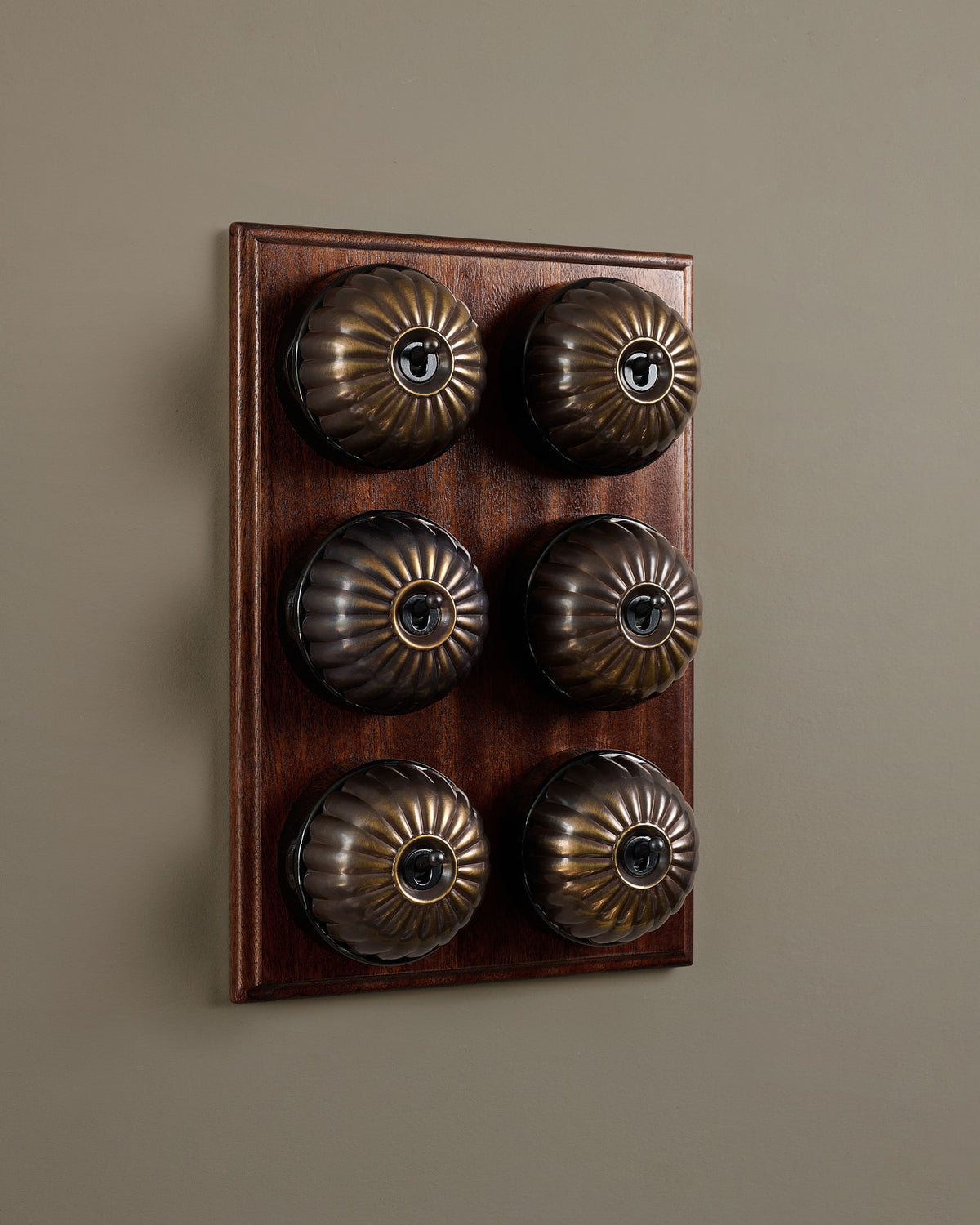 The Jelly Toggle Switch (6 Gang & Mahogany Finish Pattress) - Oxidised Brass with Black Base. TEST