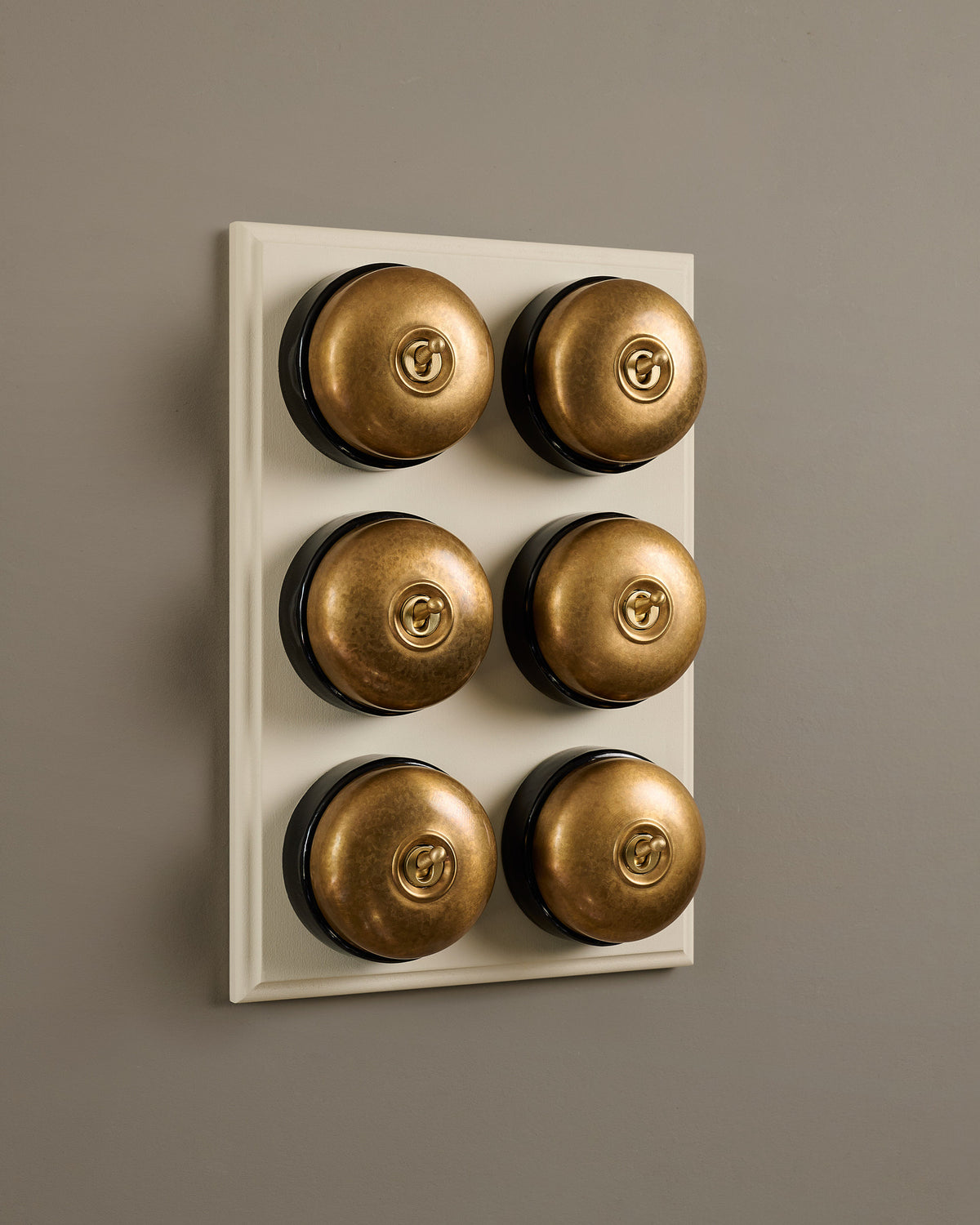 The Dolly Toggle Switch (6 Gang & Primed Maple Pattress) - Aged Brass with Black Base. TEST