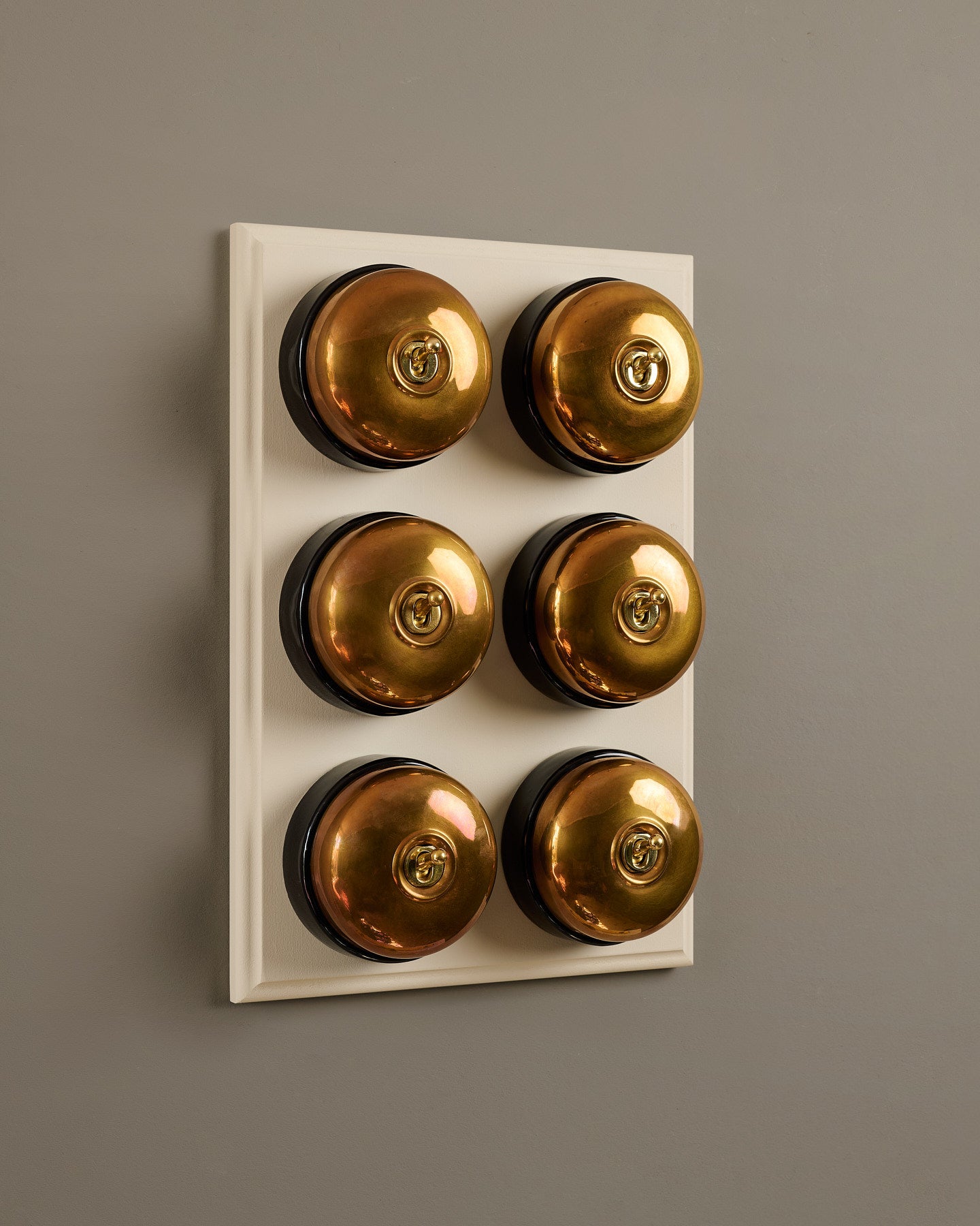 The Dolly Toggle Switch (6 Gang & Primed Maple Pattress) - Heirloom Brass with Black Base.